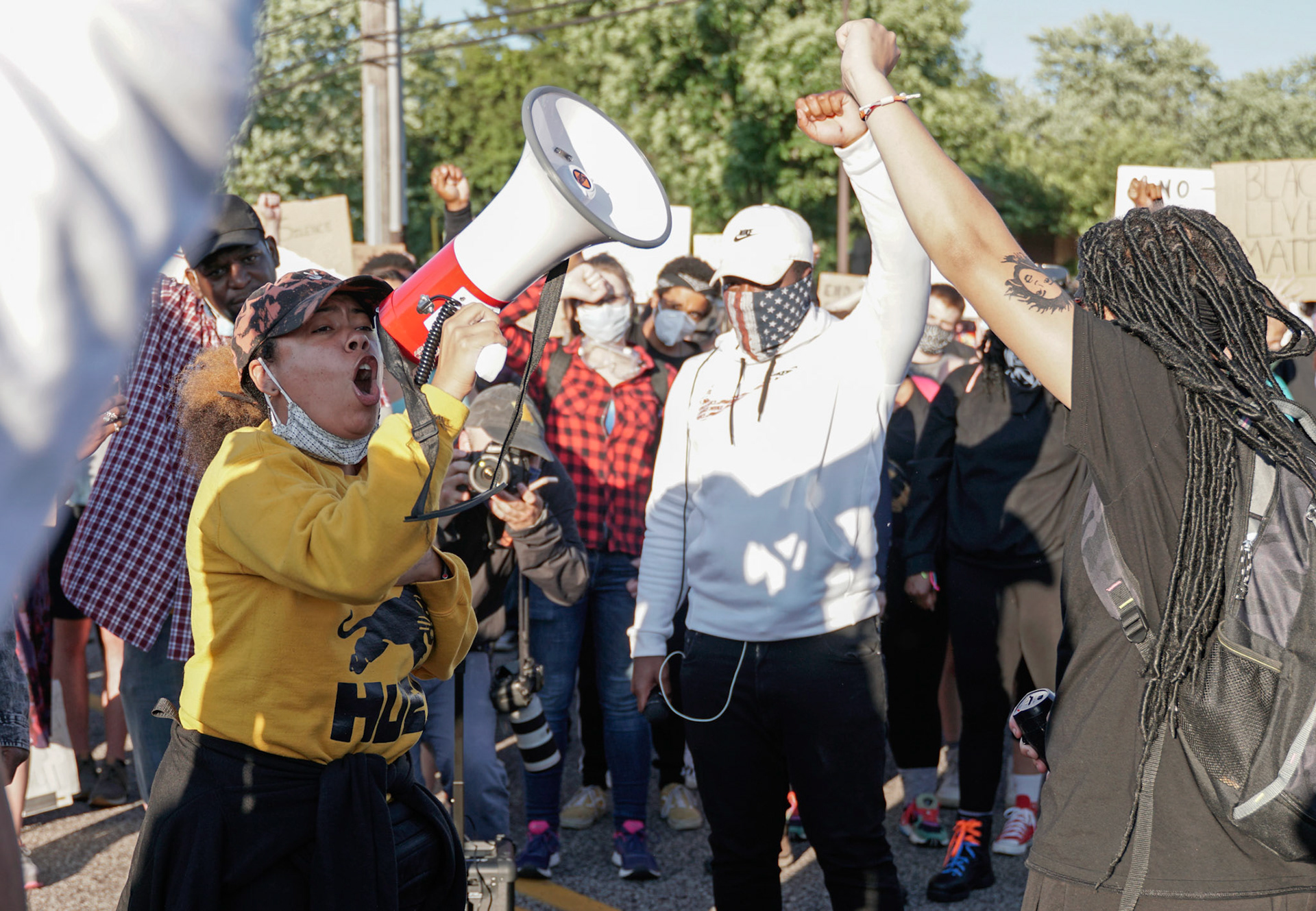 An activist speaks into a megaphone in Florissant, Mo., during a protest on Wednesday, June 10, 2020. Protestors gathered to call for the removal of Florissant detective Joshua Smith after a video was captured of him striking an unarmed man with his car and arresting the man.