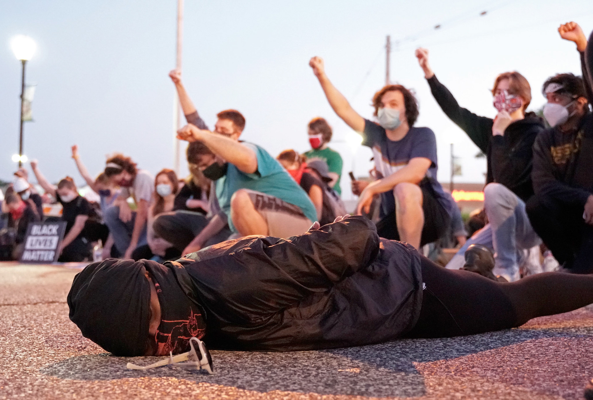 A protestor lays in the road at an intersection in Florissant, Mo., during a protest on Wednesday, June 10, 2020. Activists gathered to call for the removal of Florissant detective Joshua Smith after a video was captured of him striking an unarmed man with his car and arresting the man.