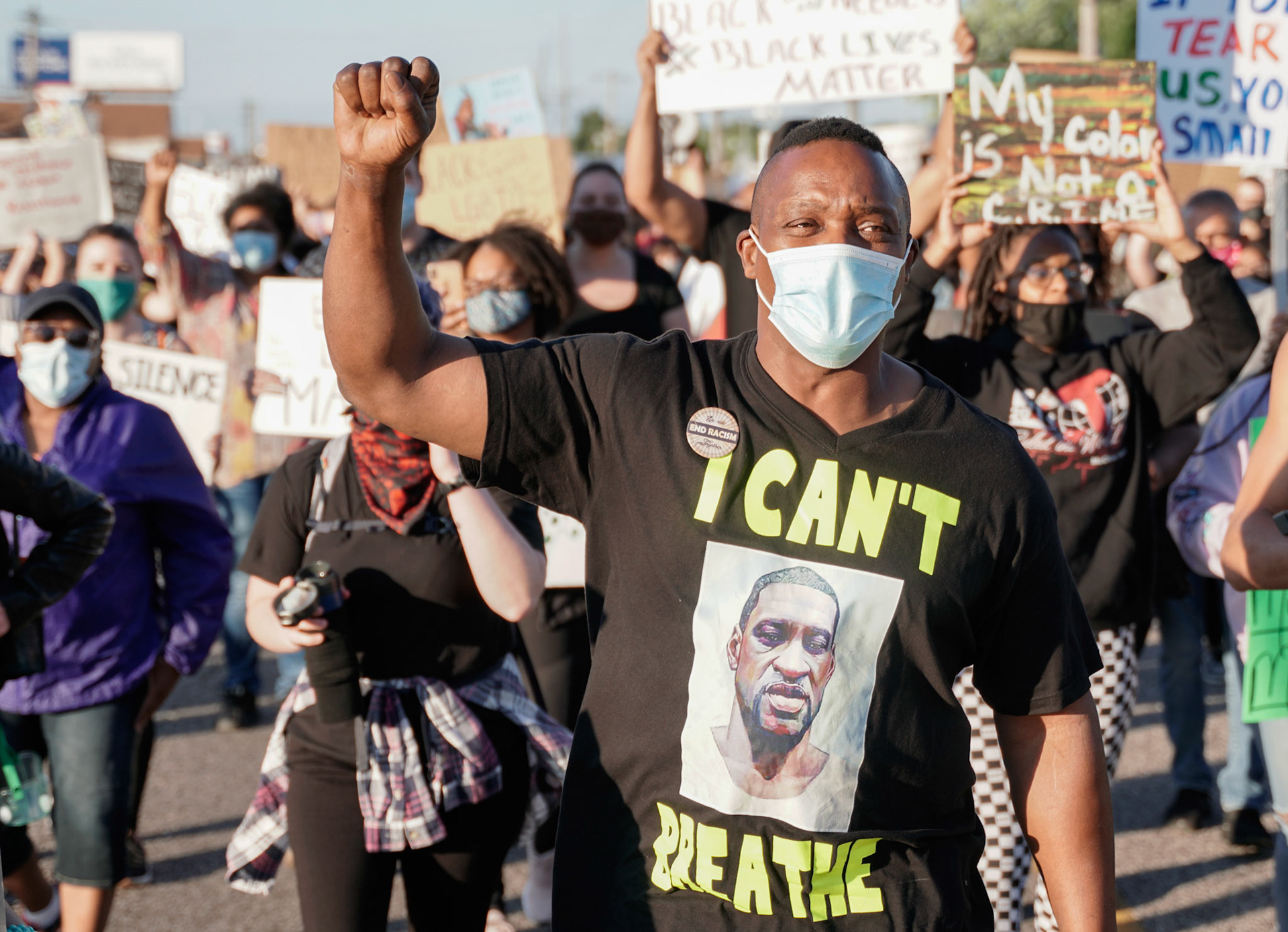An activist holds up his fist in Florissant, Mo., during a protest on Wednesday, June 10, 2020. Protestors gathered to call for the removal of Florissant detective Joshua Smith after a video was captured of him striking an unarmed man with his car and arresting the man.