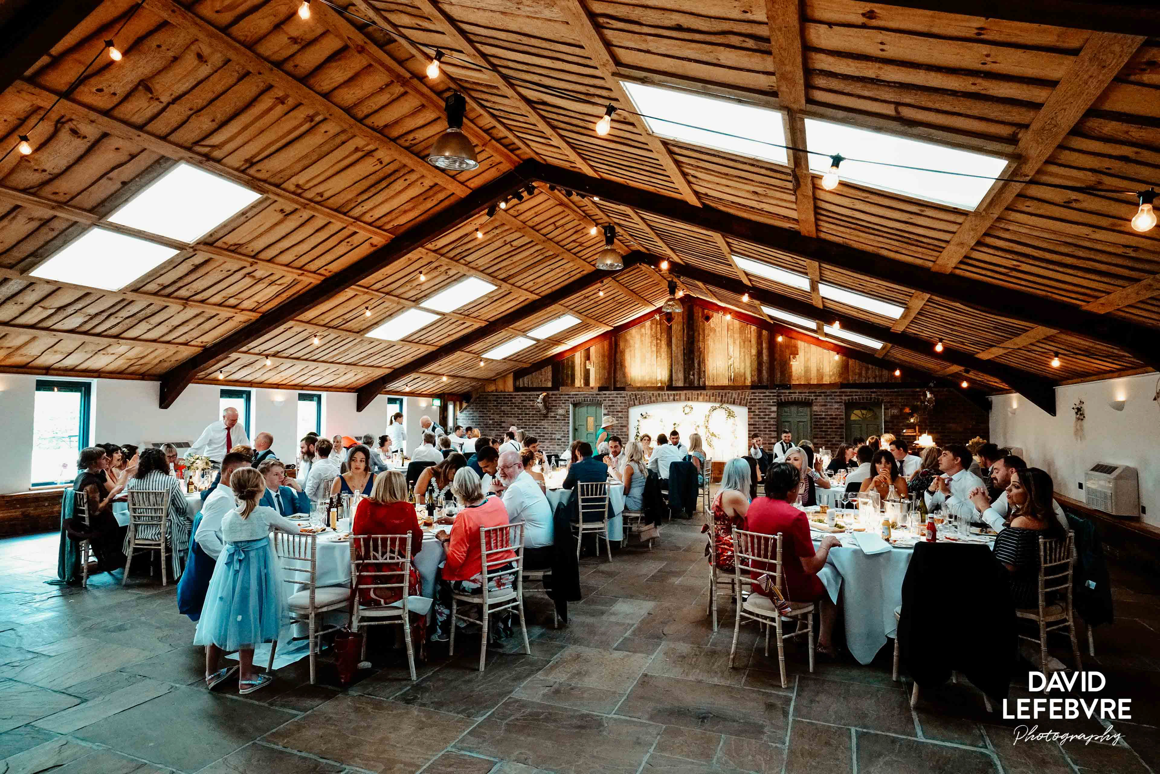 wide angle view of wedding guests in owen barn house