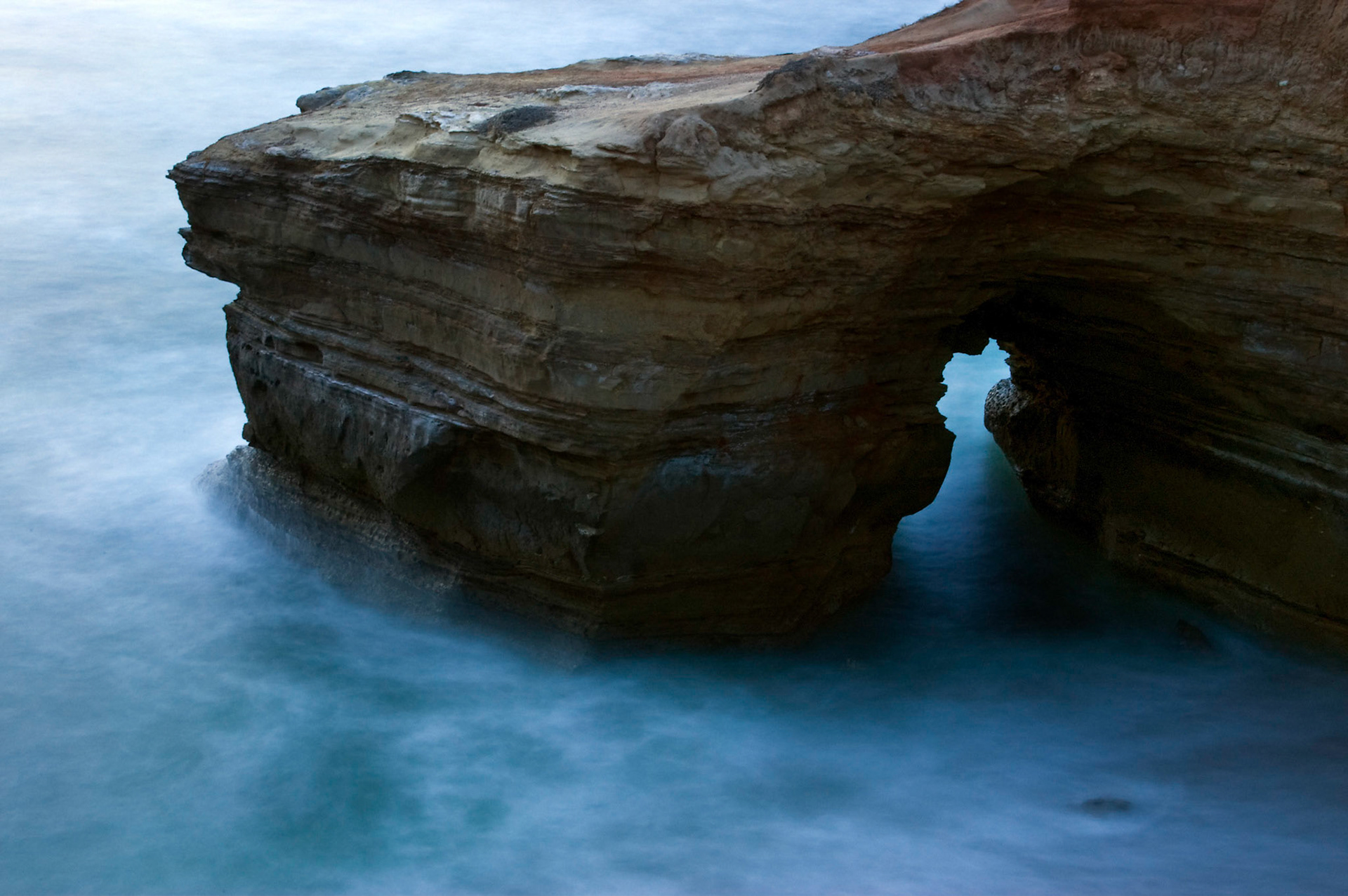 A cliffs and natural arch at Sunset Cliffs Natural Park in San Diego California.