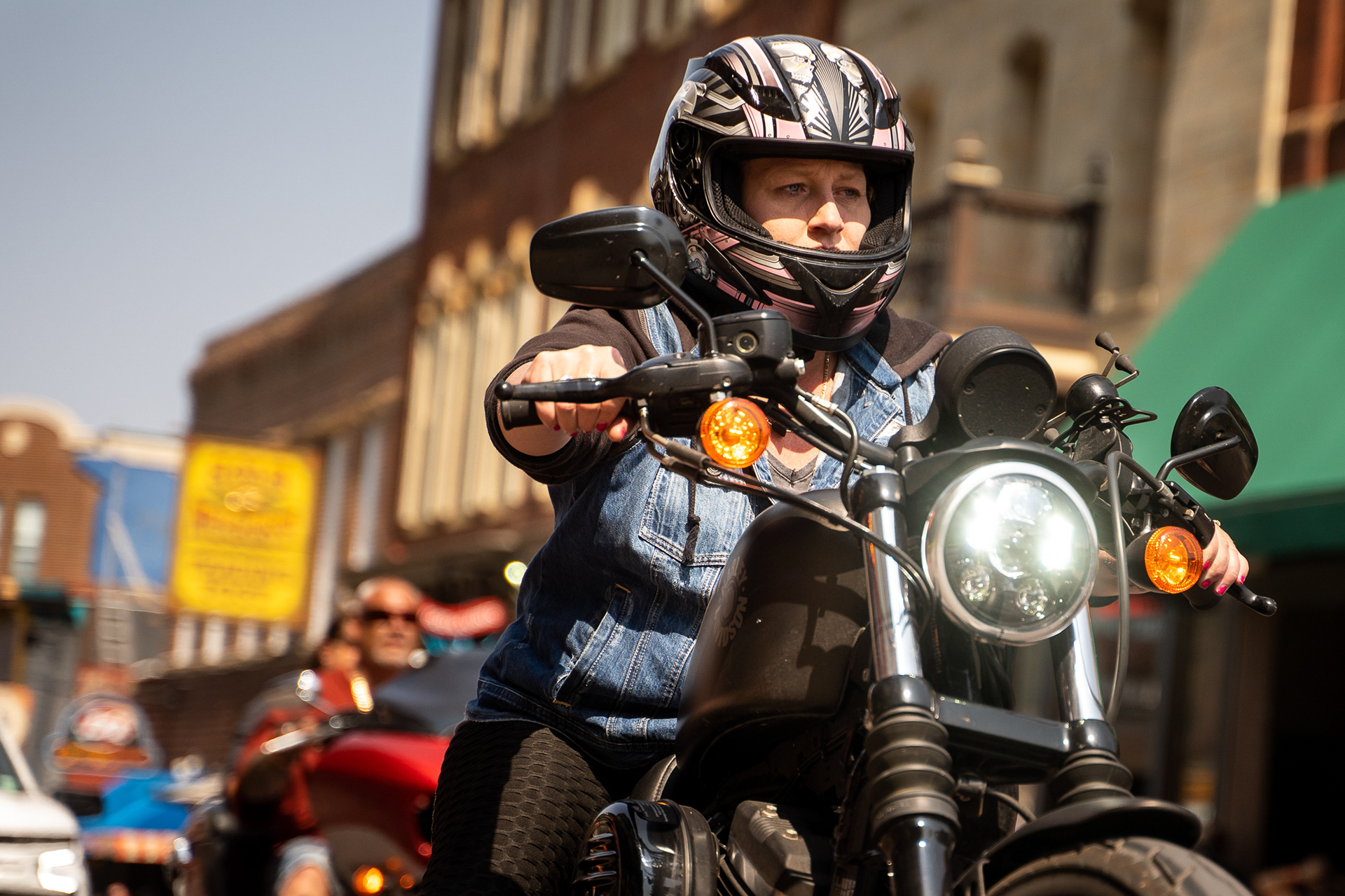 A motorcycle rider makes their way through downtown Deadwood, South Dakota during the fourth day of the 81st Sturgis Motorcycle Rally. 08.09.21.