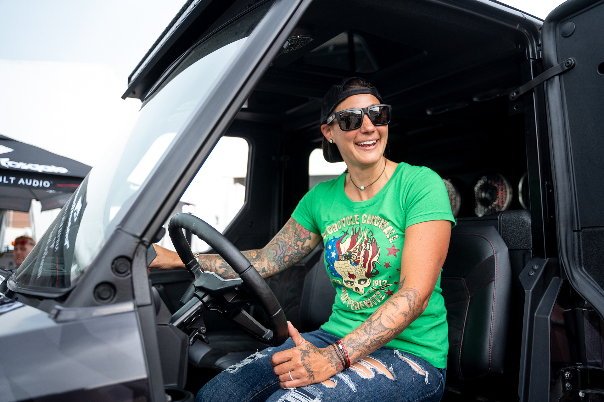 Jody Perewitz, the grand marshal for this year’s rally, reacts to a sound system on display at the Rockford Fosgate booth during the opening day of the 81st Sturgis Motorcycle Rally in Sturgis, South Dakota. 08.06.21.
