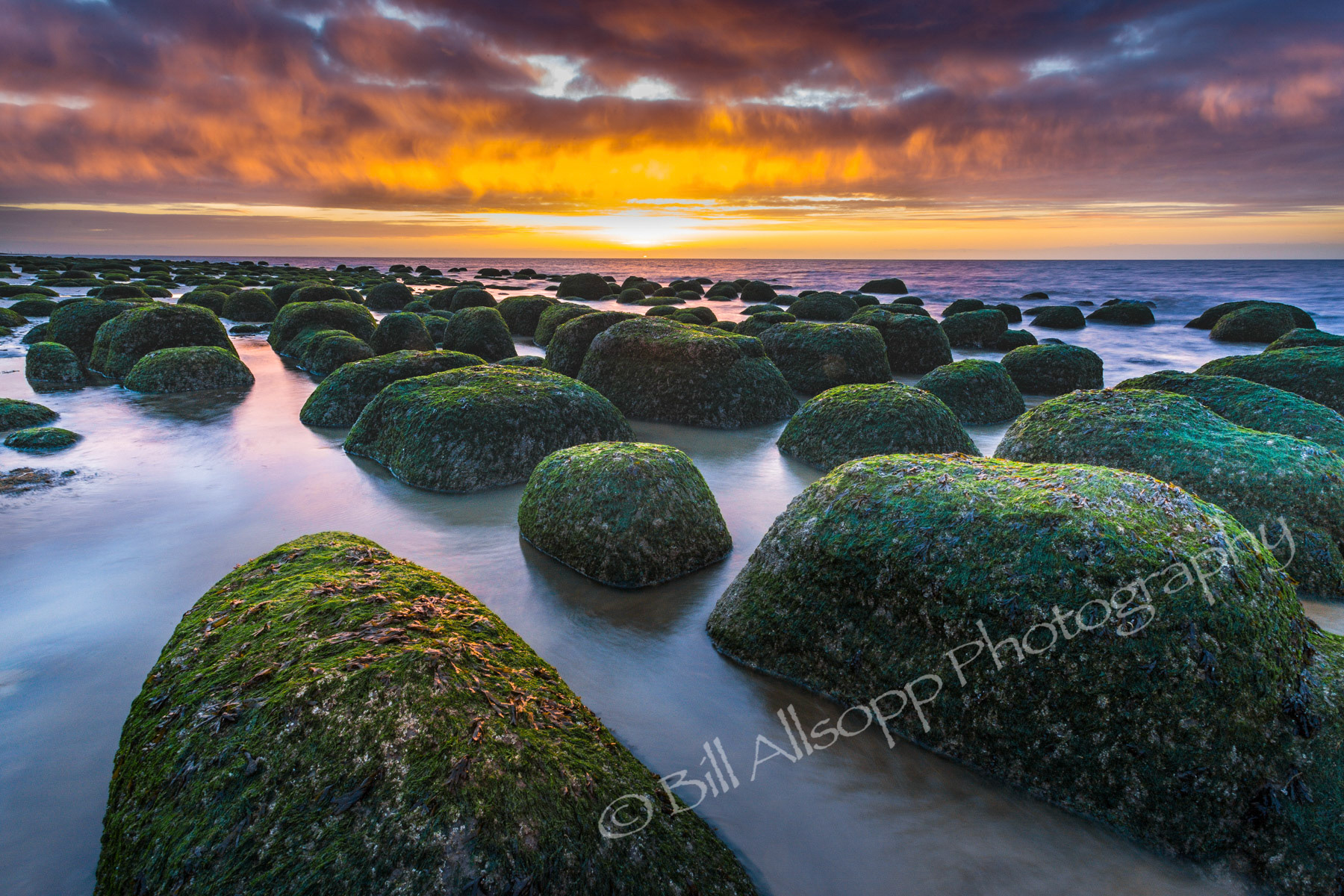 Boulders on Hunstanton beach at sunset.
