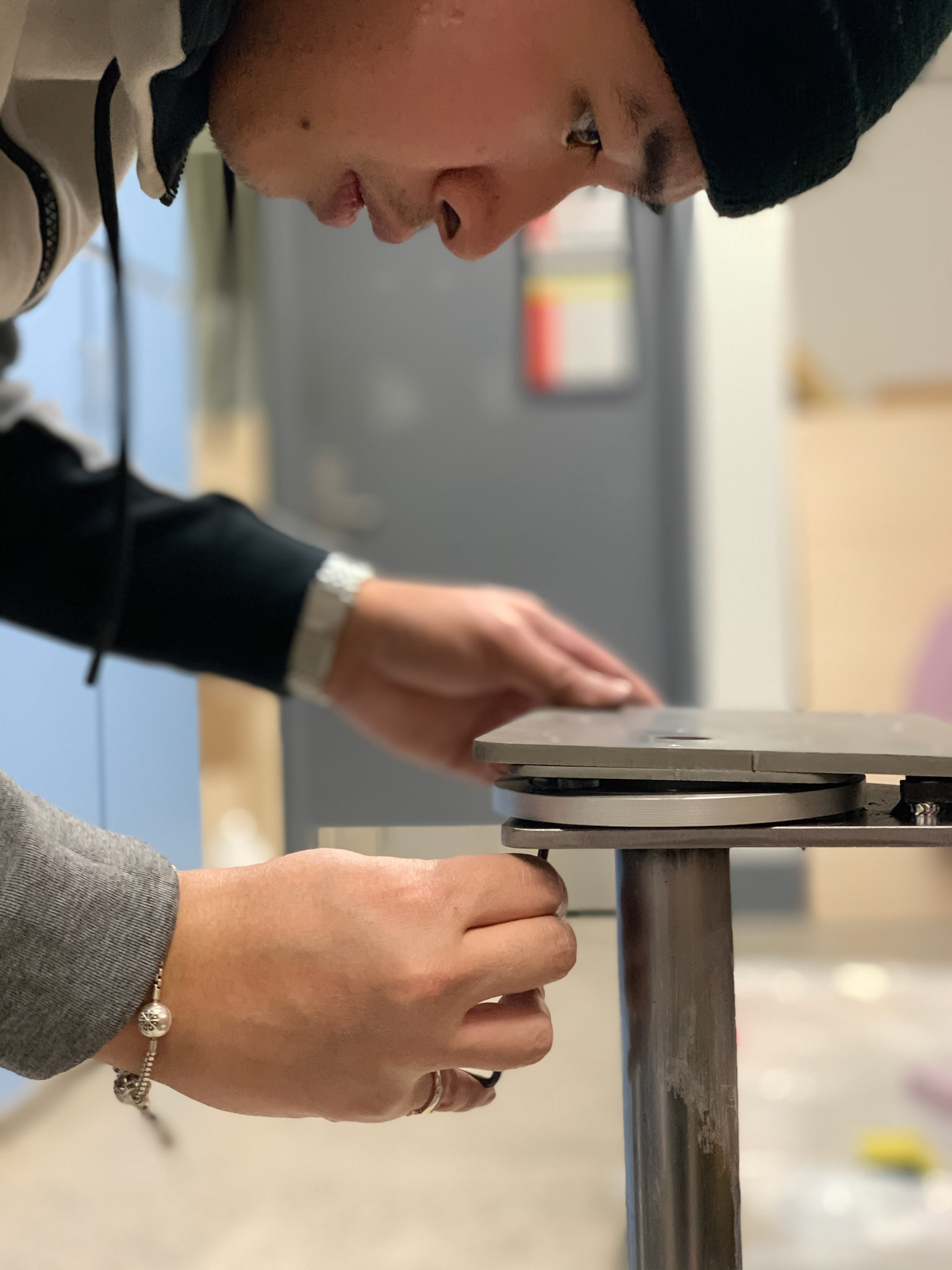 Fitting the machined screws into threaded holes in the steel plate