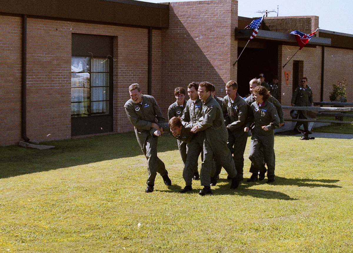 Having grabbed Aaron on his way back from the crew bus, Dagger student pilots race toward the dunk tank.