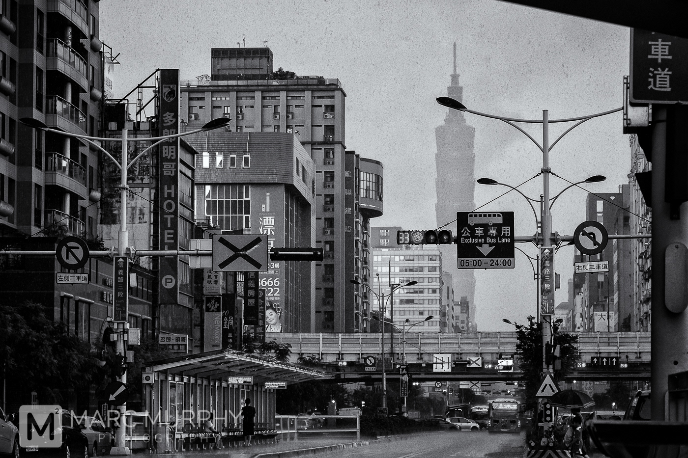 Rainy Black and White Taipei Taiwan in the Zhongzheng District with Buildings, People, Cars, Buses, Signs and Taipe 101