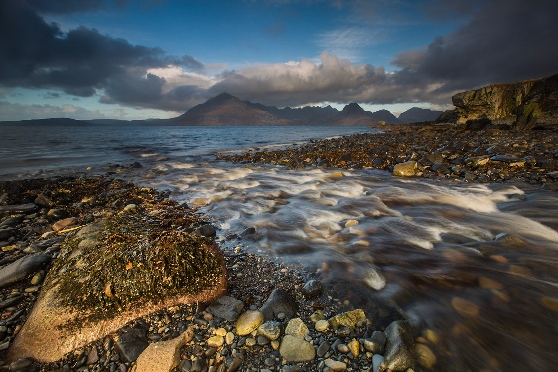 River flowing into the seas of Loch Scavaig at Elgol, with the Cuillin mountains across the water. An alternative title I have used is  "Between the Showers" - as it was tricky keeping the camera dry between the downpours.