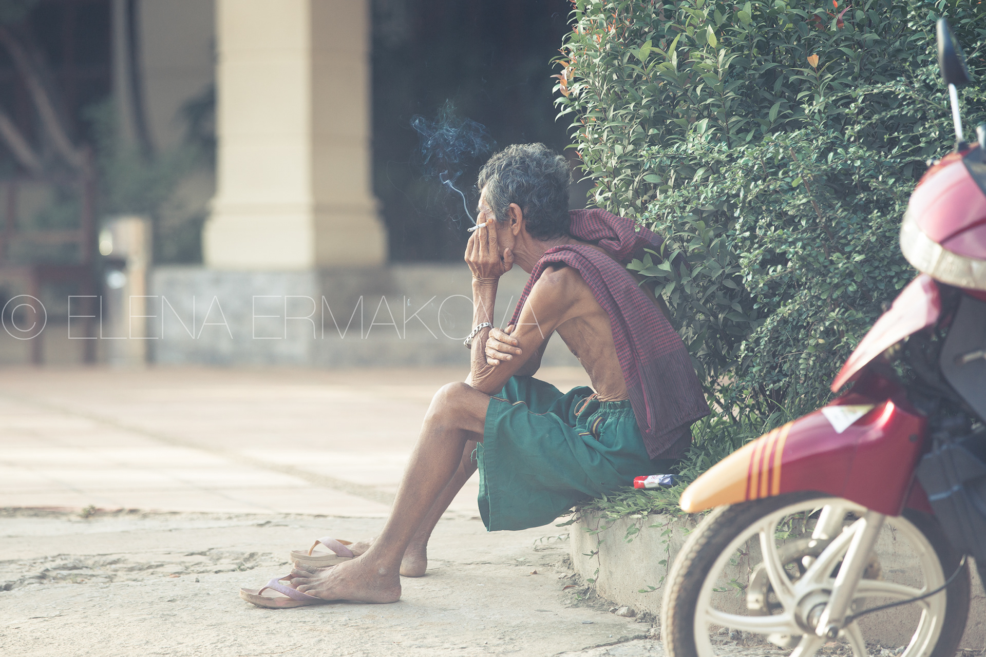 Motorbike taxi driver takes a rest, Phnom Penh, Cambodia. Travel photography by Elena Ermakova.