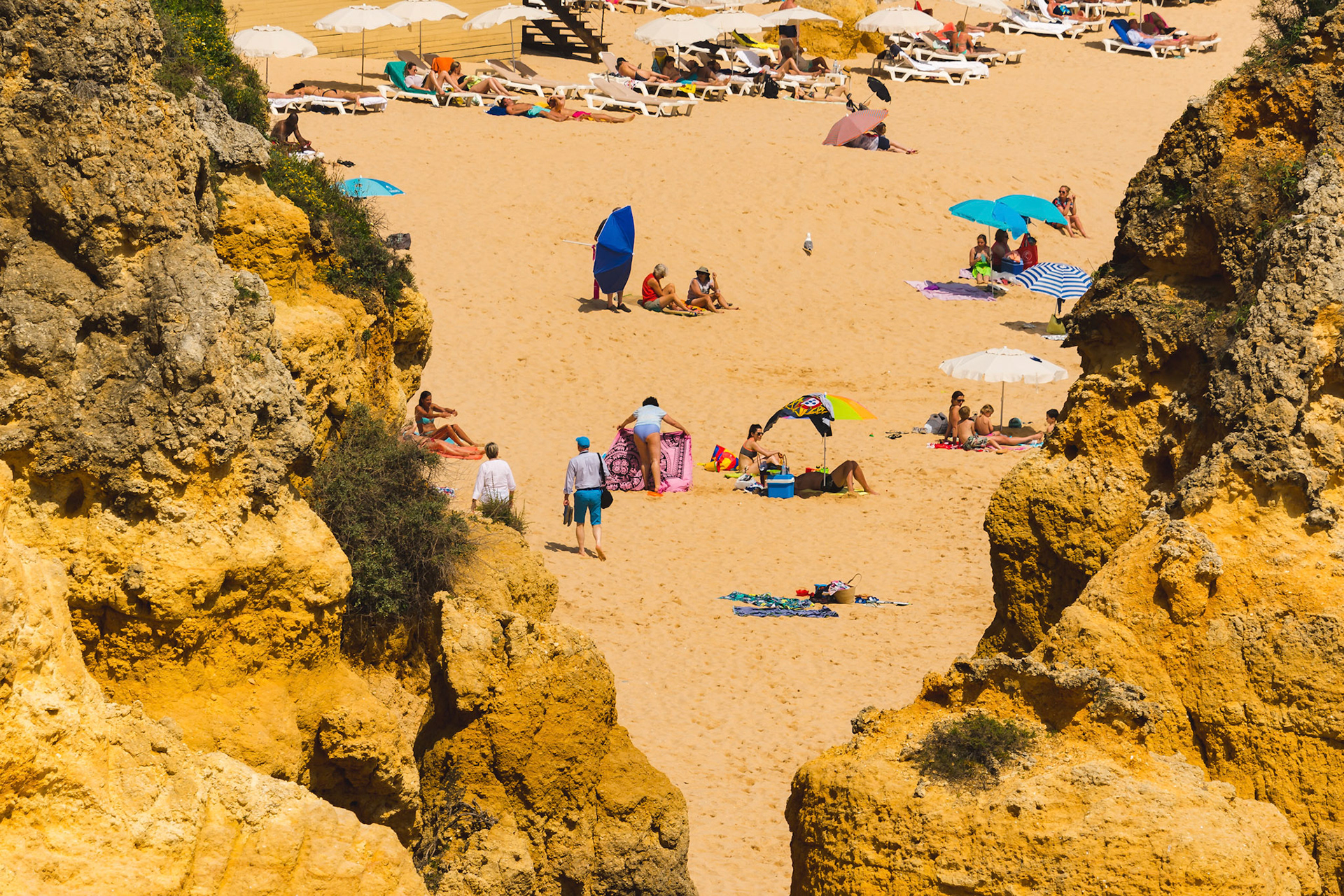 Happy family vacation at Paradise. People relaxing on the yellow sand of beach. Happy sea lifestyle. Young family, man and woman rest on the beach of ocean. Love travel