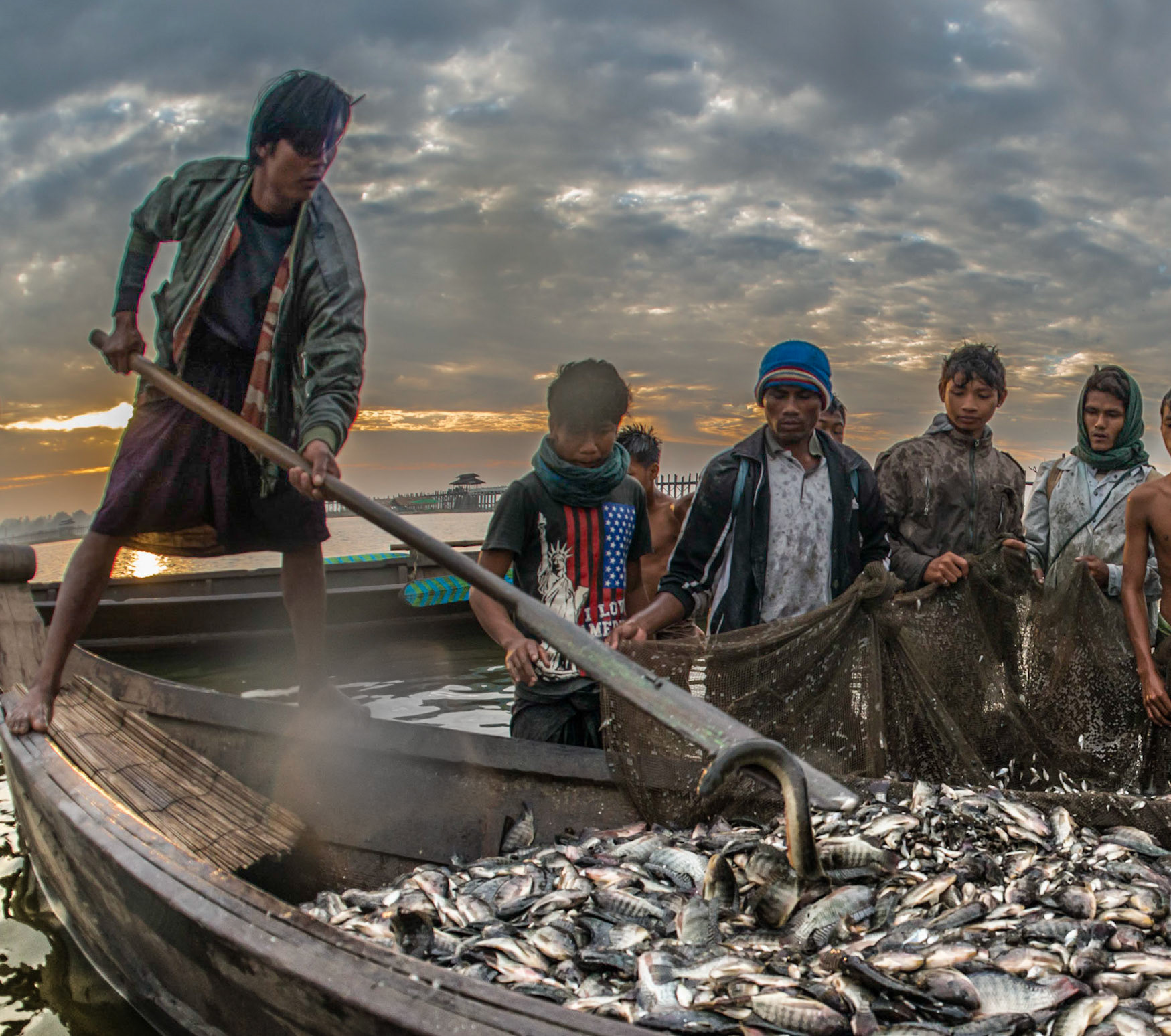 Fisherman in Burma dealing with water snake.