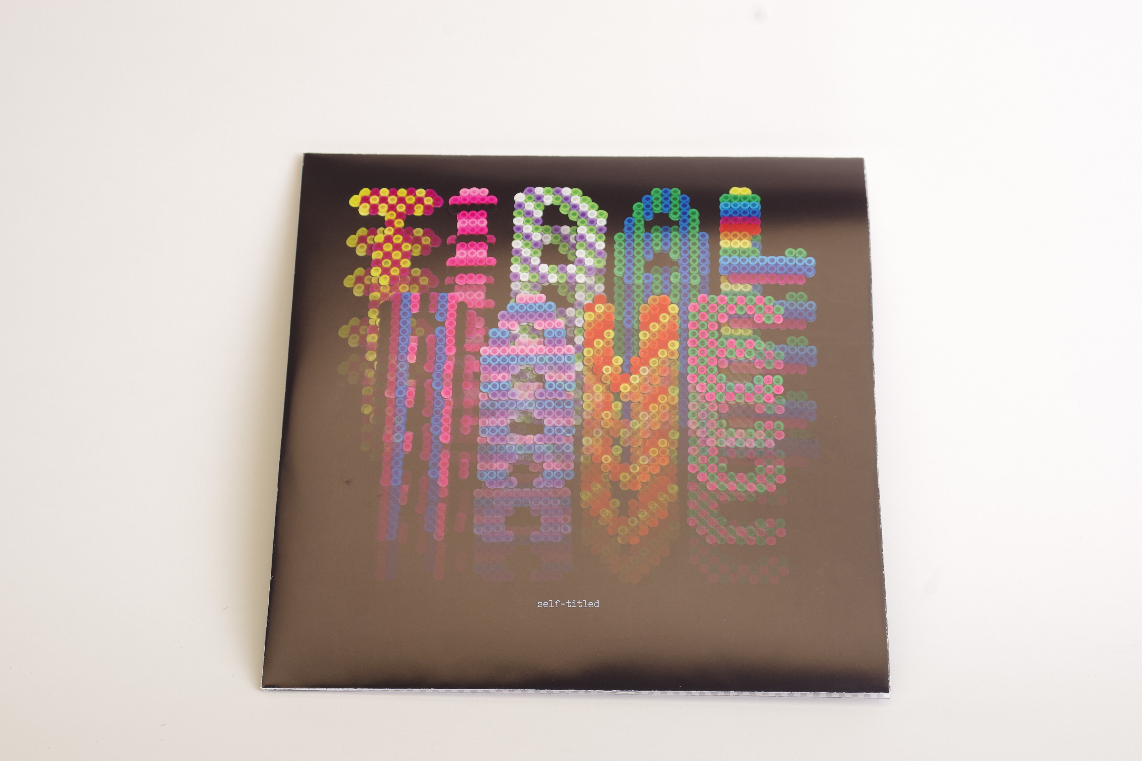 The type for the album cover was constructedfrom fusible plastic beads, then scanned and edited in Photoshop.