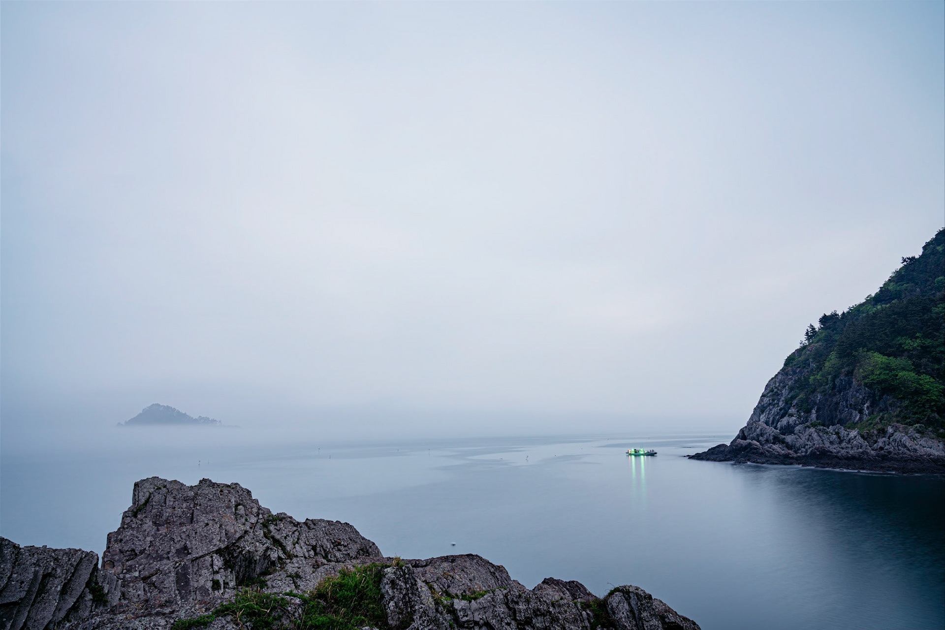 Saryangdo, South Korea - 02 MAY 2020: Stormy spring weather moves in and shrouds the islands around Saryangdo in haze and fog. This area is a popular destination for fishing and free diving for shellfish.