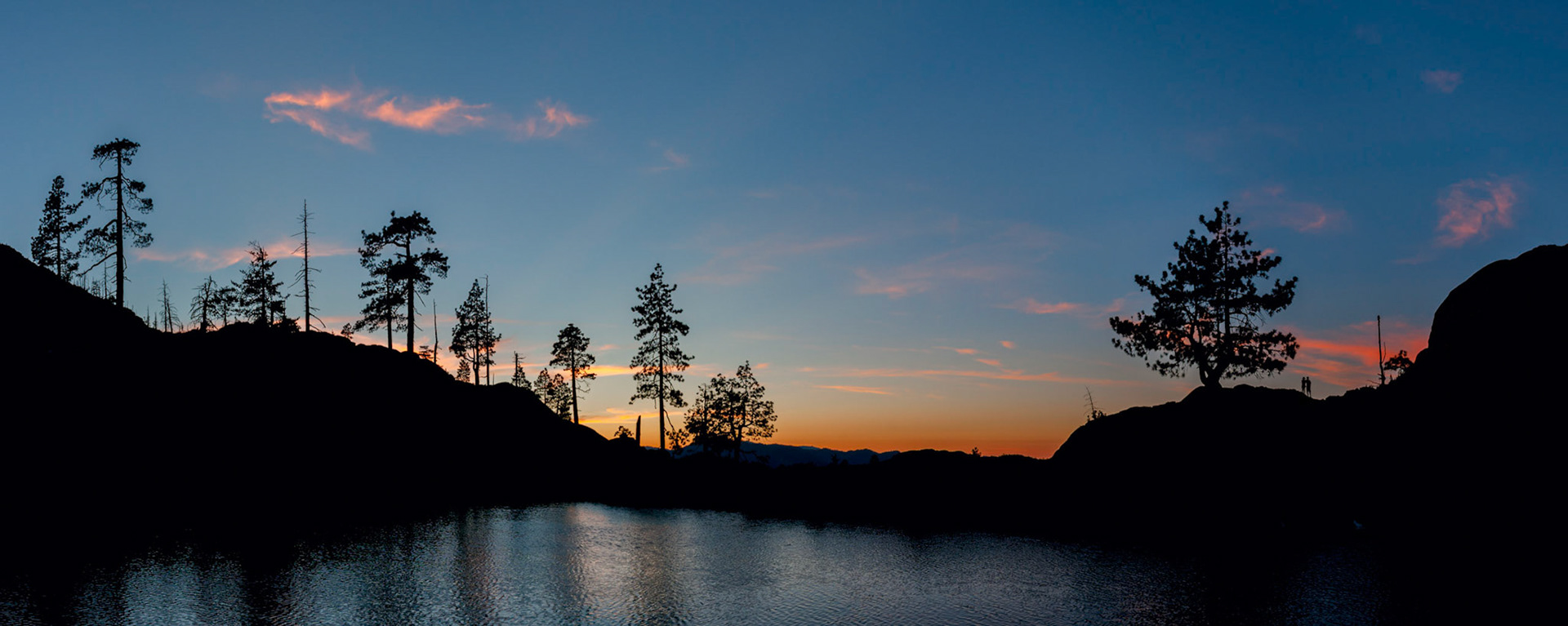 Sunset at Towhead Lake, Red Buttes WildernessI took my two oldest, Elliott and Gwendolyn, backpacking in the nearby Red Buttes Wilderness last week. Over 5 miles in to a remote lake in a rugged wilderness may have been a bit much for a 7 and 9 year old (and especially an out-of-shape 33 year old) but we had an amazing trip and really enjoyed the 3 days that we spent there. One neat thing about our timing is that July is when many hikers that are traveling the Pacific Crest Trail reach the California/Oregon border. Since most of our hike was on the PCT, we were able to chat with several through hikers that had started their journey over 2 months ago. It has always been a dream of mine to someday hike the PCT so it's fun to meet people who are doing it! The kids were pretty blown away once I described what it was all about too :-)If you look closely at the photo you'll see Elliott and Gwendolyn near the large tree on the right hand side.