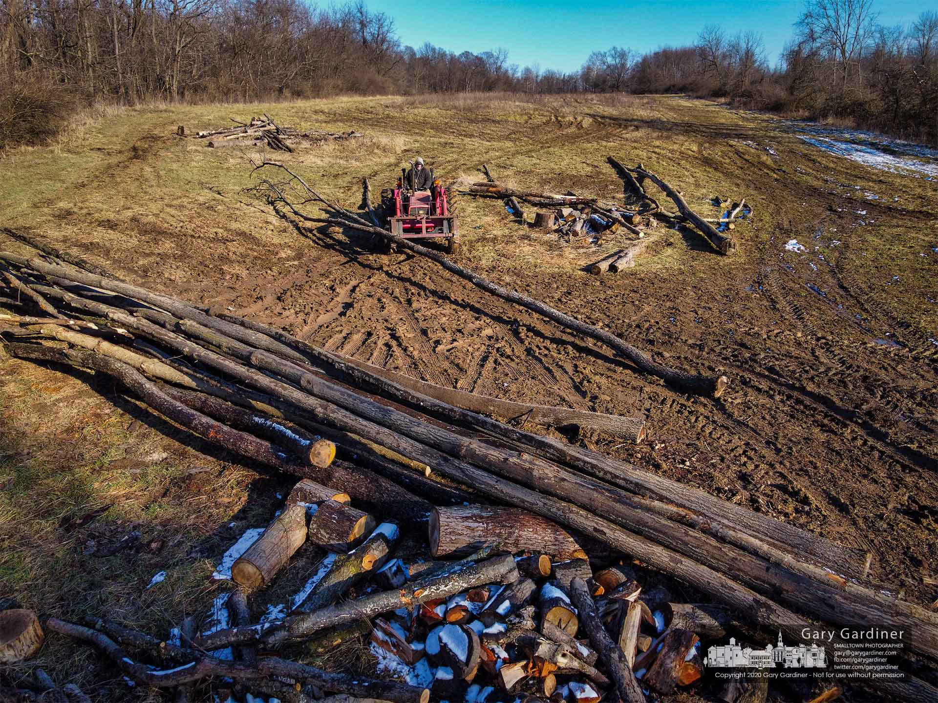 Kevin Scott hauls felled trees to a collection point as he helps clear trees from land that will be planted with crops in the spring. My Final Photo for Jan. 19, 2021.