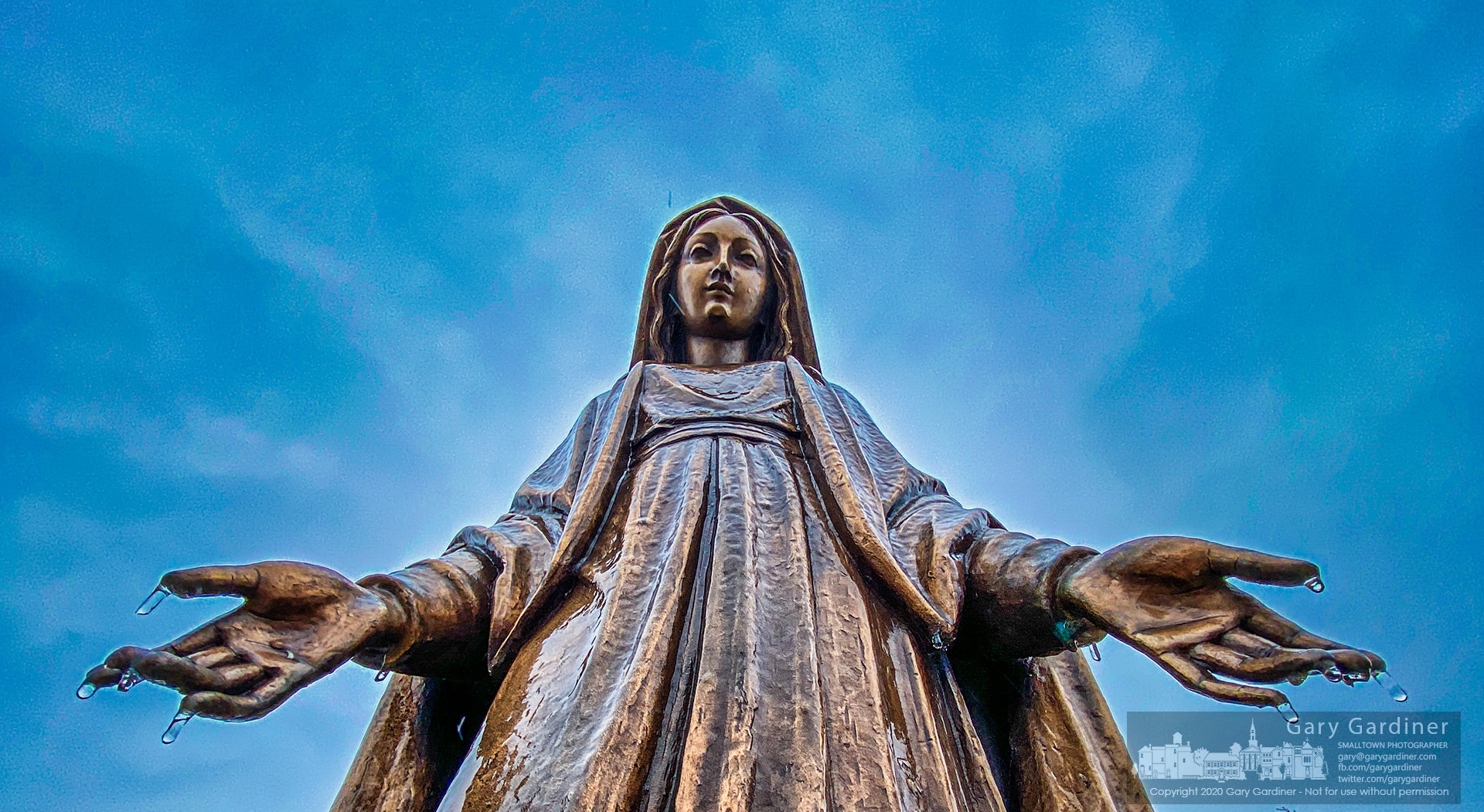 Icicles hang from the fingers of the statue of Mary in front of St. Paul the Apostle church after an overnight storm brought freezing rain. My Final Photo for Nov. 1, 2021.
