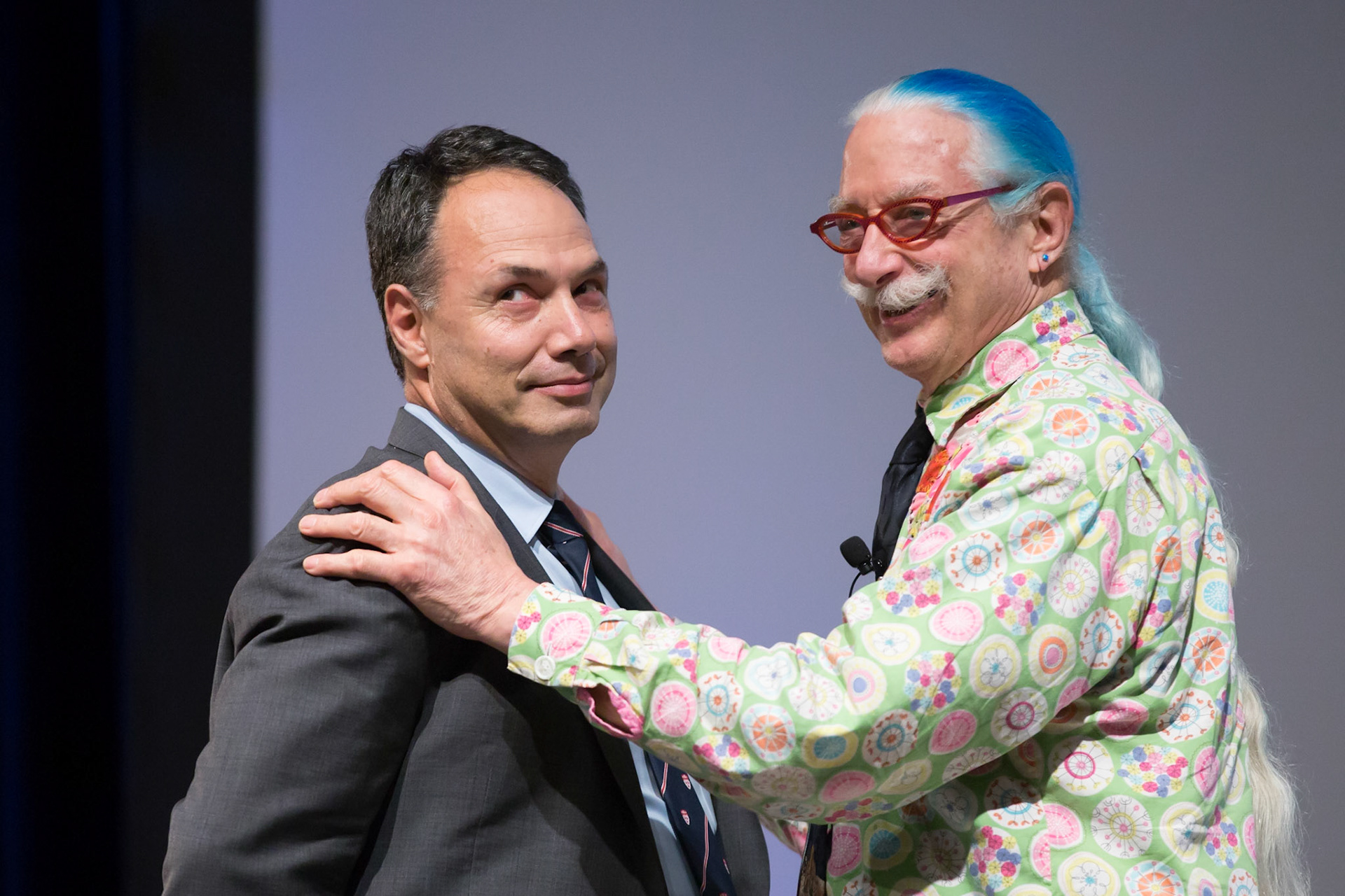  Professor Masad Damha wonders whether joining Patch Adams on stage was, in fact,  a good idea. Trottier Symposium, October 2017.