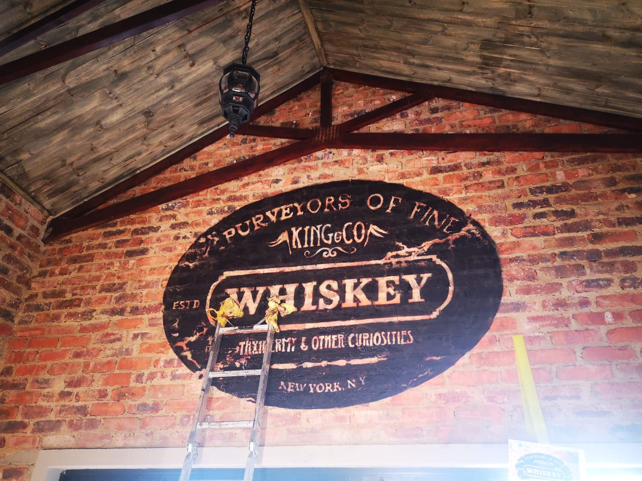 kitchen vintage whiskey logo black on brick airbrush and paintbrush wall art mural