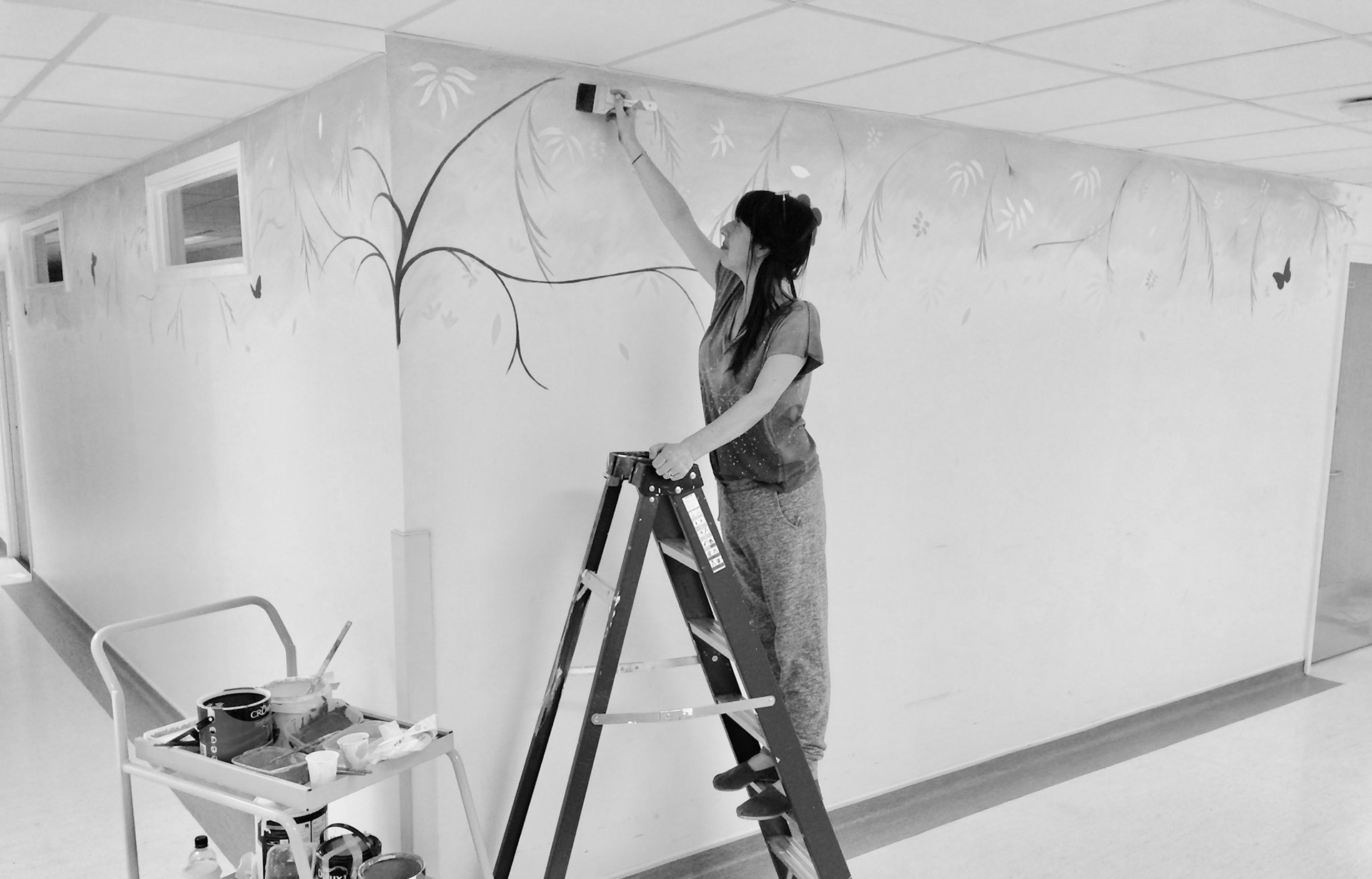 Lynne painting a mural