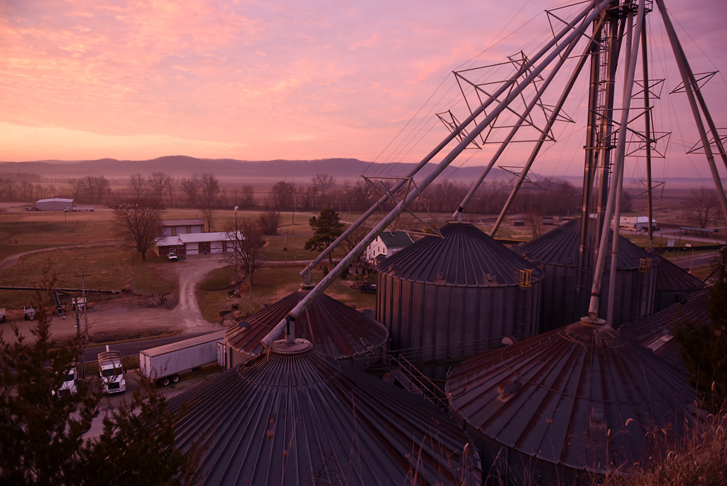 The sun rises over the river bottom Sunday, December 8, 2019 in Rhineland, Missouri. The land beyond the granary is where the town of Rhineland used to be located before the houses moved up the hill to avoid flooding.