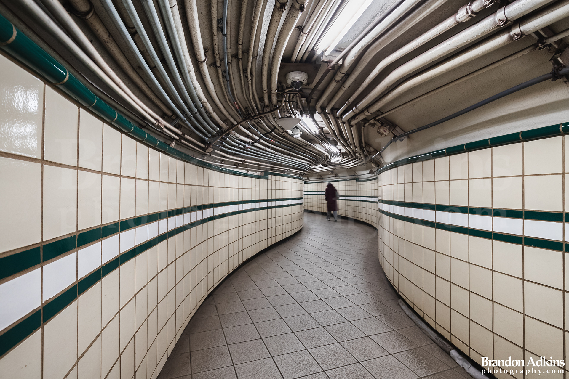 Fine art photography of the 9th Street Station PATH tunnel with one person walking away in New York City, NY