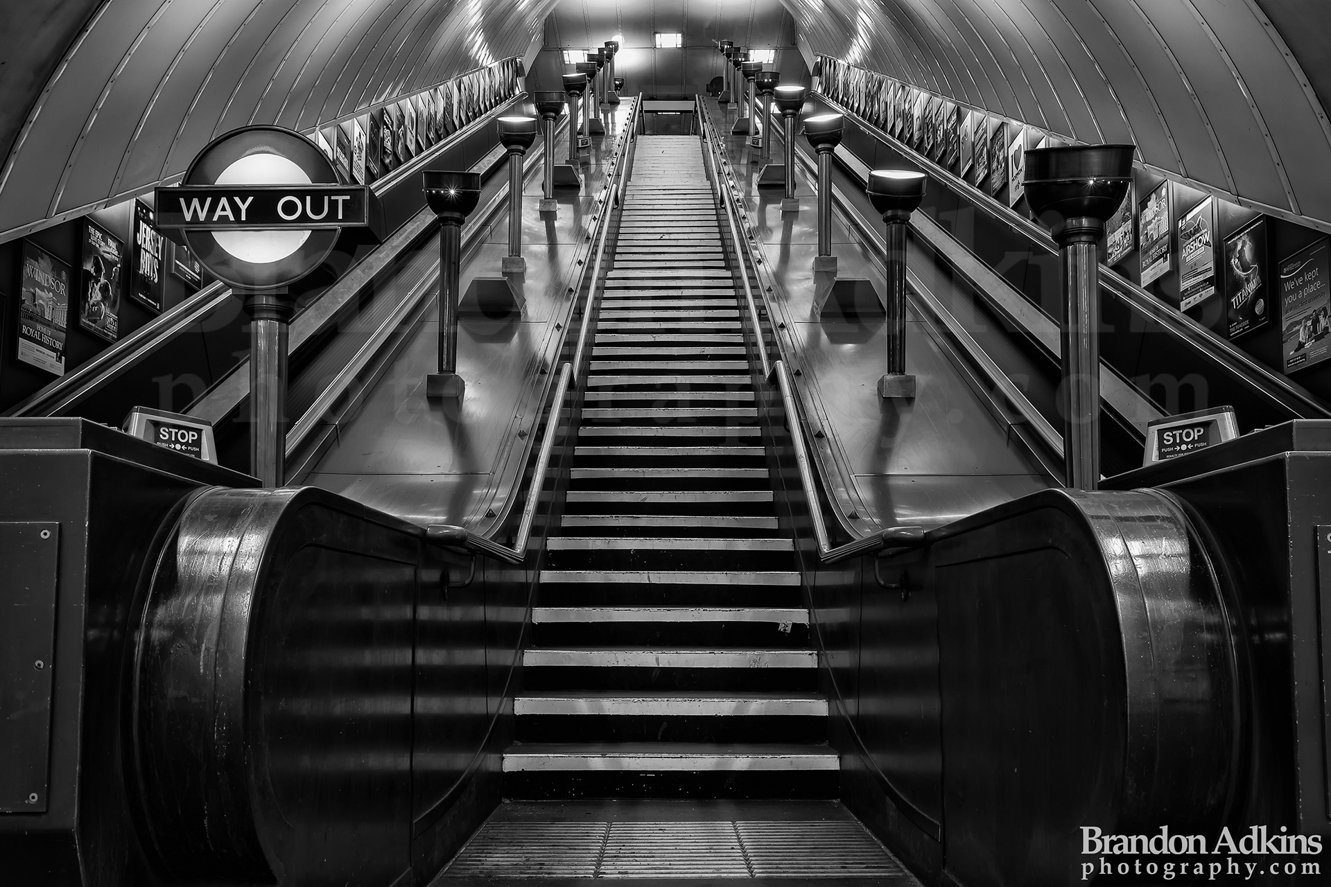 Fine art photograph of stairs leading out of London underground station with historic "Way Out" exit sign in black and white