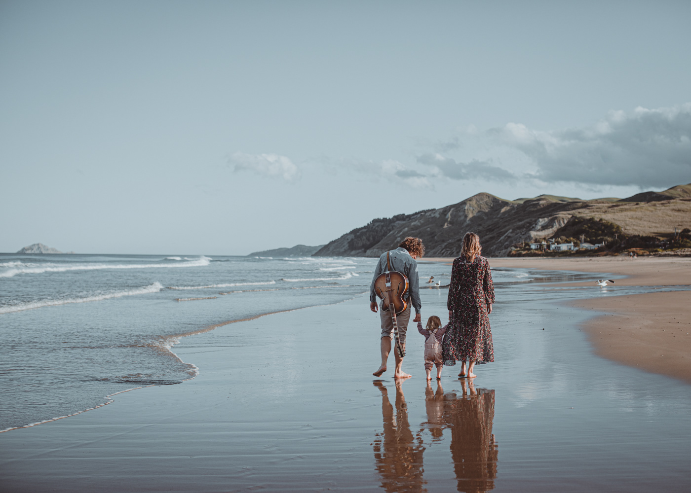Rachel, Matiu and little Aria enjoying a beach stroll in the late afternoon