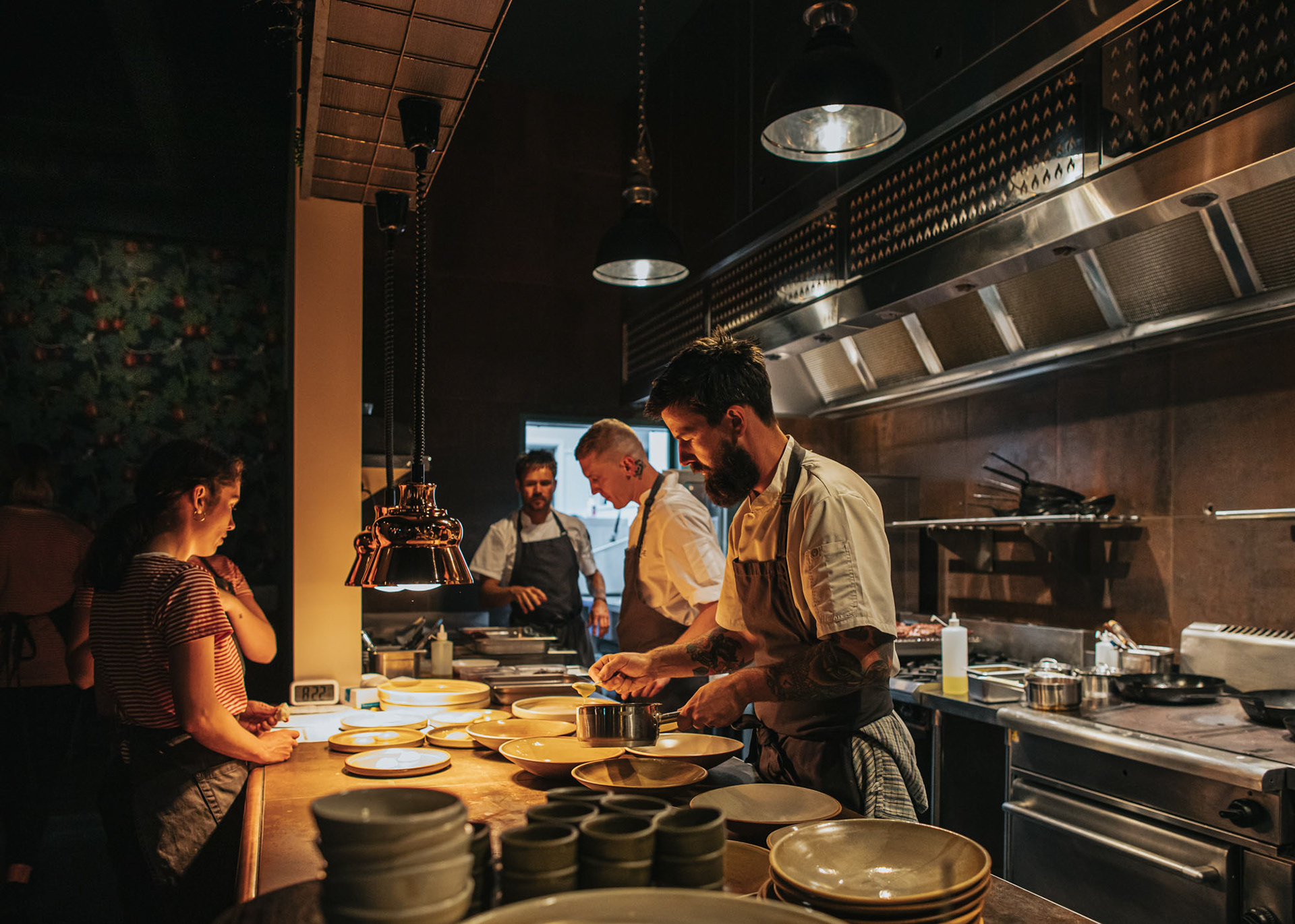 Central Fire Station's Wildfire F.A.W.C! event - Chefs plating up a course with wait staff watching on