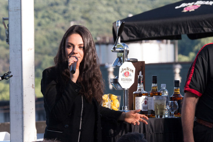 Mila Kunis speaking at the Beam Suntory Conference at the Jim Beam Distillery.