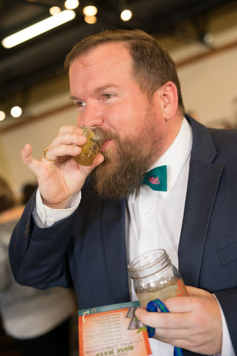 Kenny Schindler demonstrates proper pinky out mini cocktail drinking form.