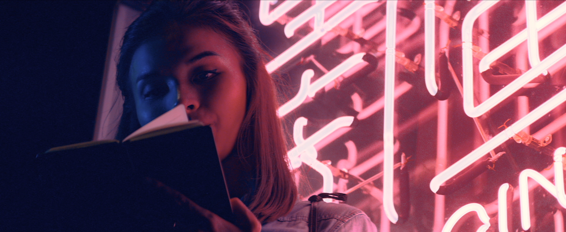 Close up shot of the female hero character using the product in front of a chinese neon sign. Location: Singapore / Asia.