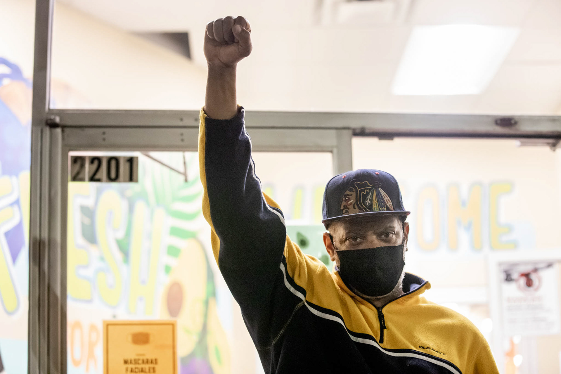 Derrick Williams, a long-time Roxbury resident, stepped out of a Roxbury storefront to stant in solidarity with protesters as they walked by.