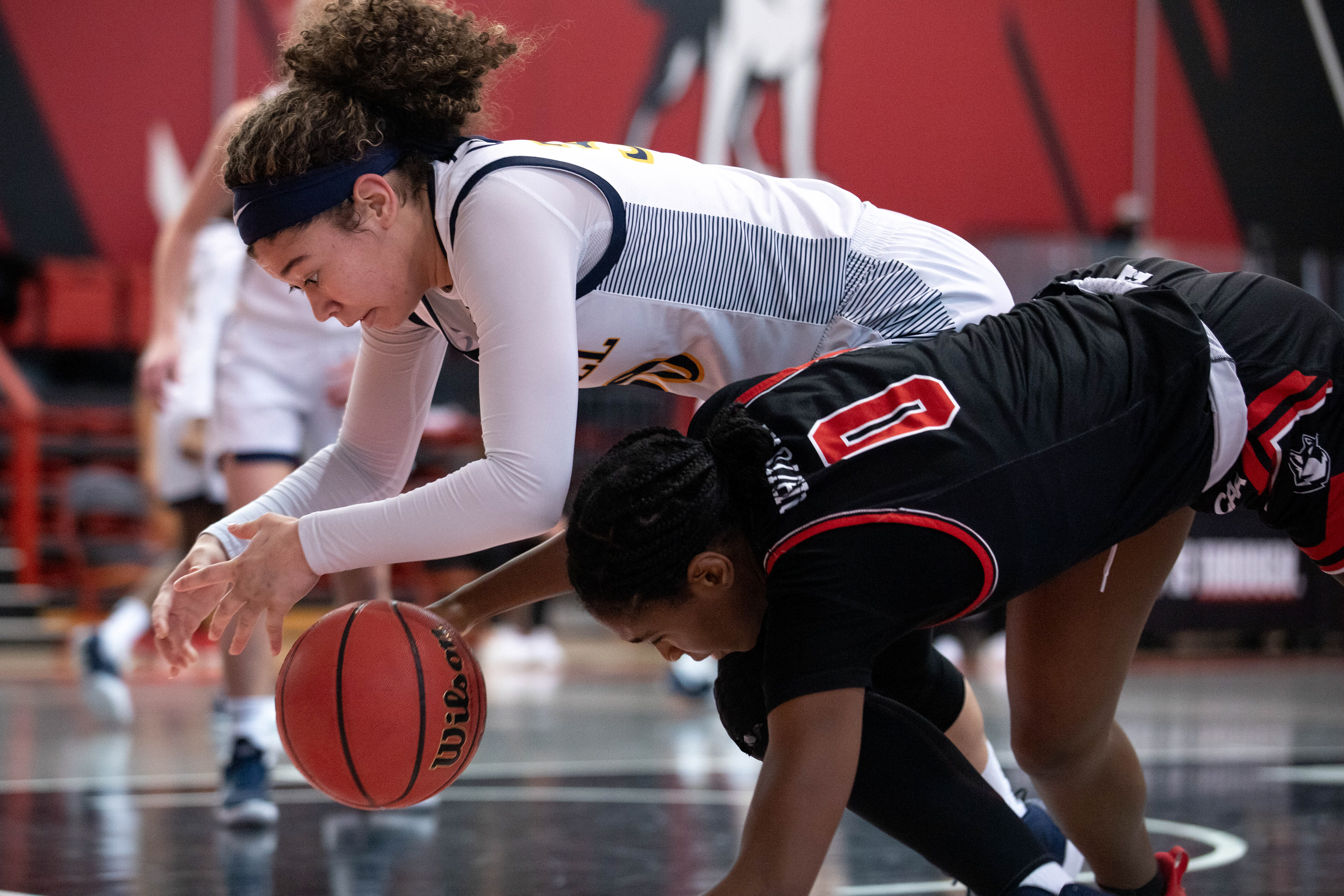 Drexel forward Mariah Leonard, left, collides with Northeastern forward Mide Oriyomi during a Northeastern home game January 31, 2021. In a closely tied game, Drexel beat Northeastern 58-56 by scoring a layup with 2.4 seconds left on hte clock.