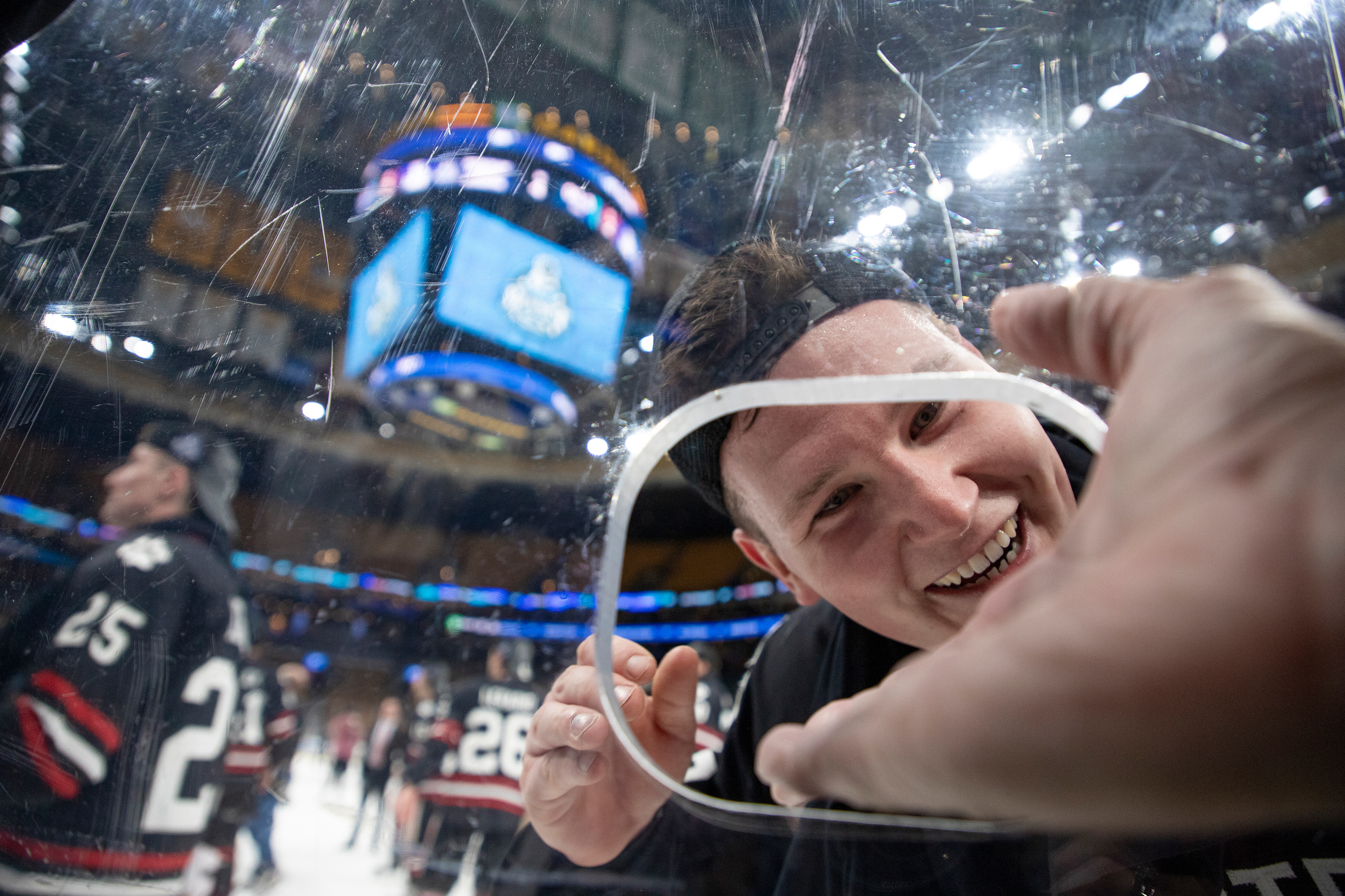 Northeastern forward Zach Solow reaches for his father, Ken Solow, as men's hockey celebrates their second consecutive Beanpot championship win Monday, February 11, 2019 at TD Garden.