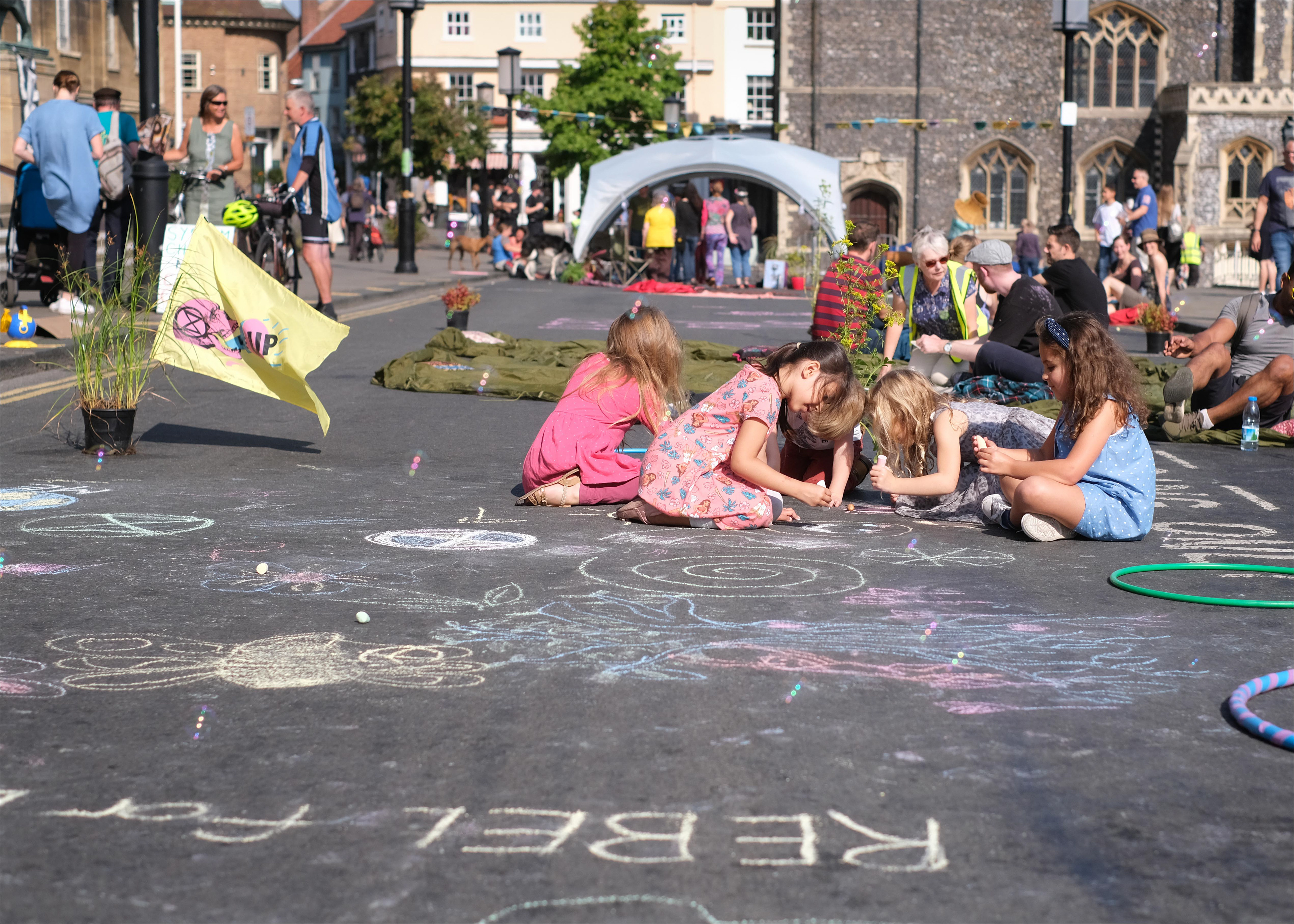 Norwich Car-Free Day 2019: To mark the first Norwich Car-Free Day we worked with various groups of activists and campaigners to take over a street in the centre of Norwich, and create a day-long family-friendly party with music, dancing, chalk art, and gigantic bubbles! My favourite element of this photo is the emphasis on childhood: Car-Free Norwich is fighting for a city safe enough for children to traverse freely, where their creativity can be unlocked.