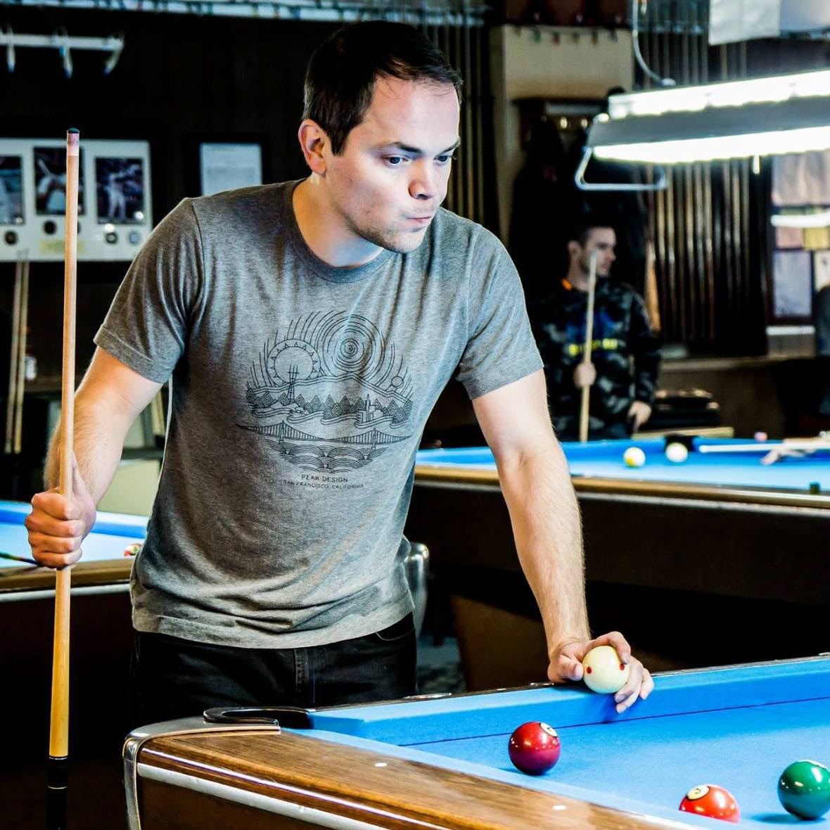 Adam playing billiards