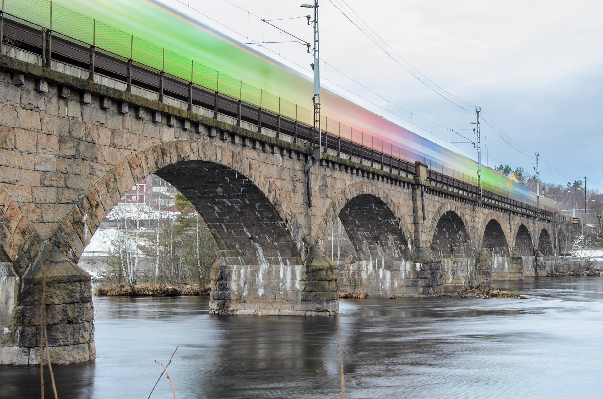 Freight train crossing Hønefoss railway bridge.
