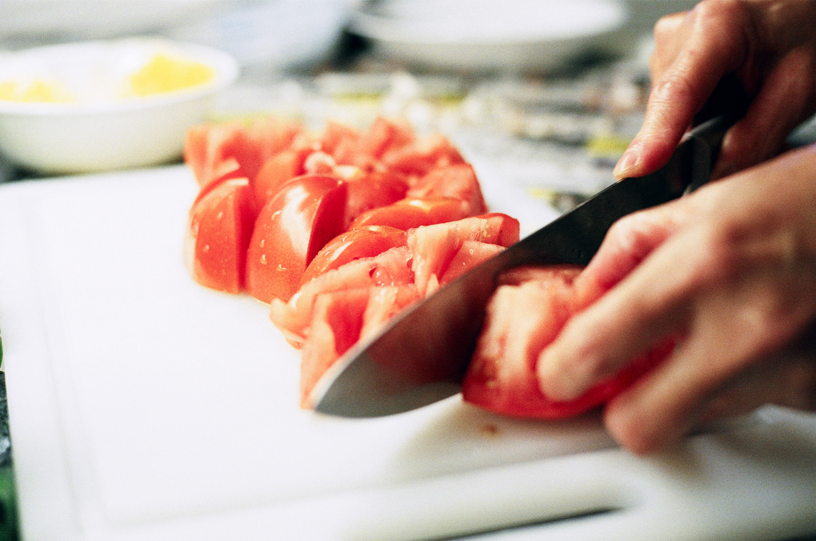 Chopping tomatoes.