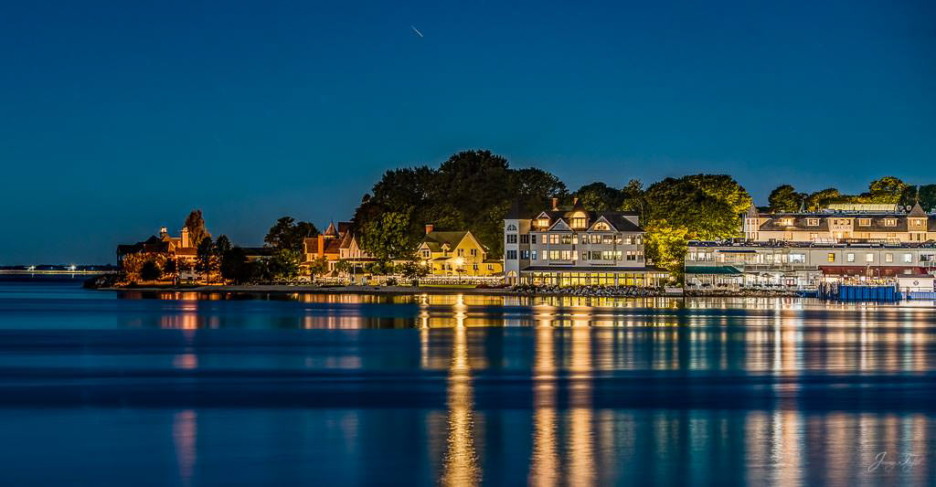 Mackinac Island at night with incredible view and reflection on the water after a passing boat