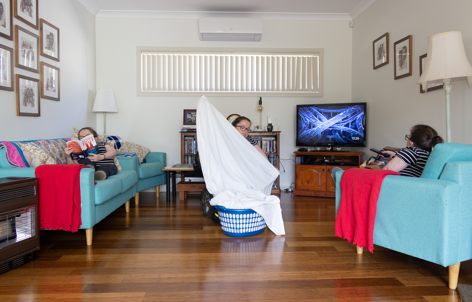 3 images of Mel within one scene, reading, doing laundry and watching TV.