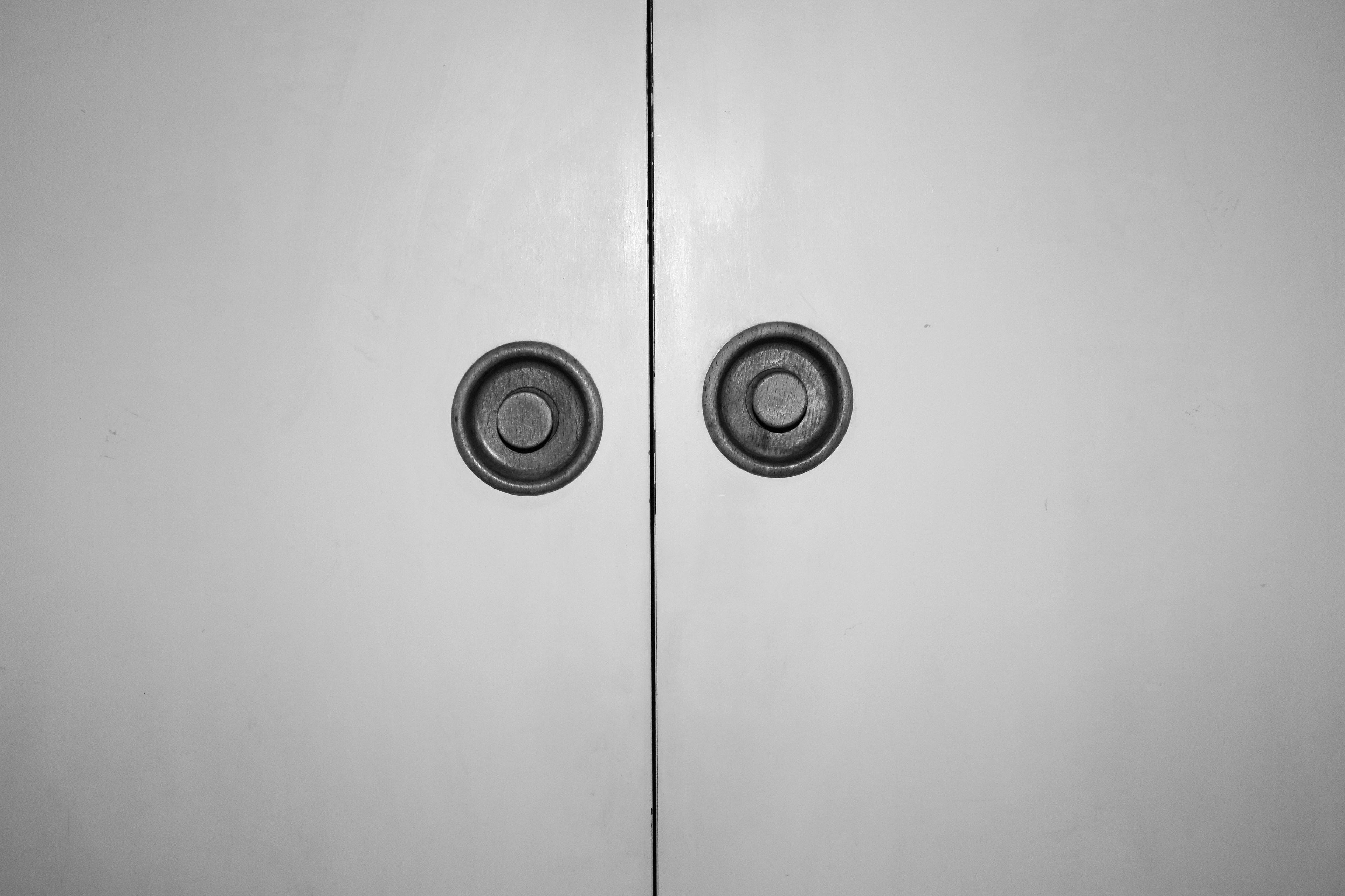 Closed doors, close up on the uneven handles