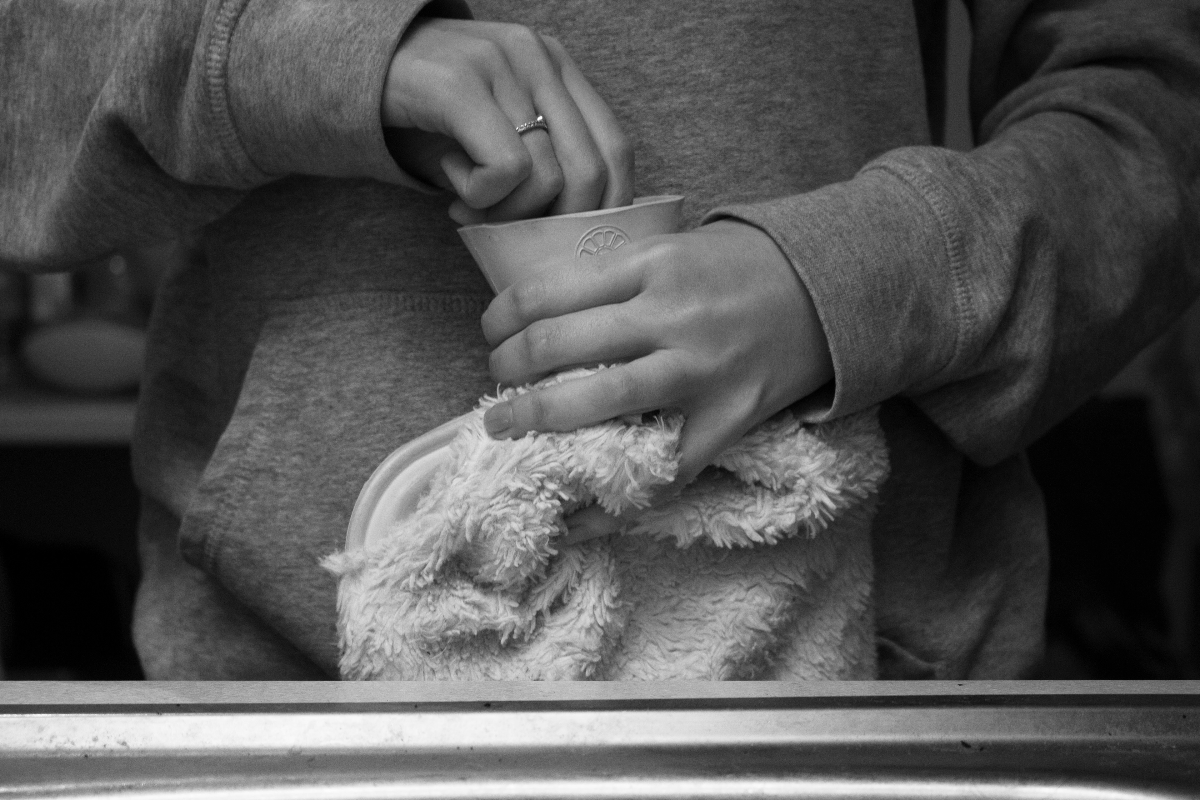 Hot water bottle lid being undone