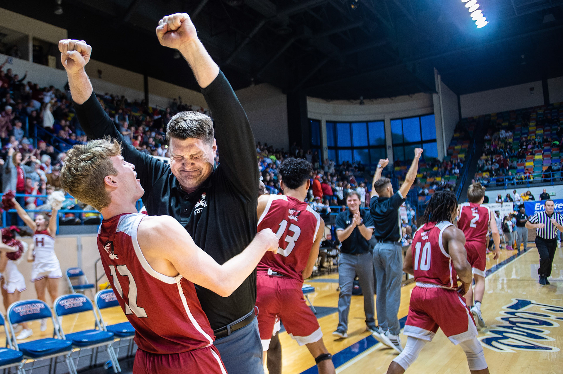 Hartselle's Ian Bodine (12) embraces head coach Faron Key as he he raises his fists in celebration after defeating Minor during the Northwest Regional Tournament semifinals at Wallace State Community College on Friday, February 14, 2020, in Hanceville, Ala.