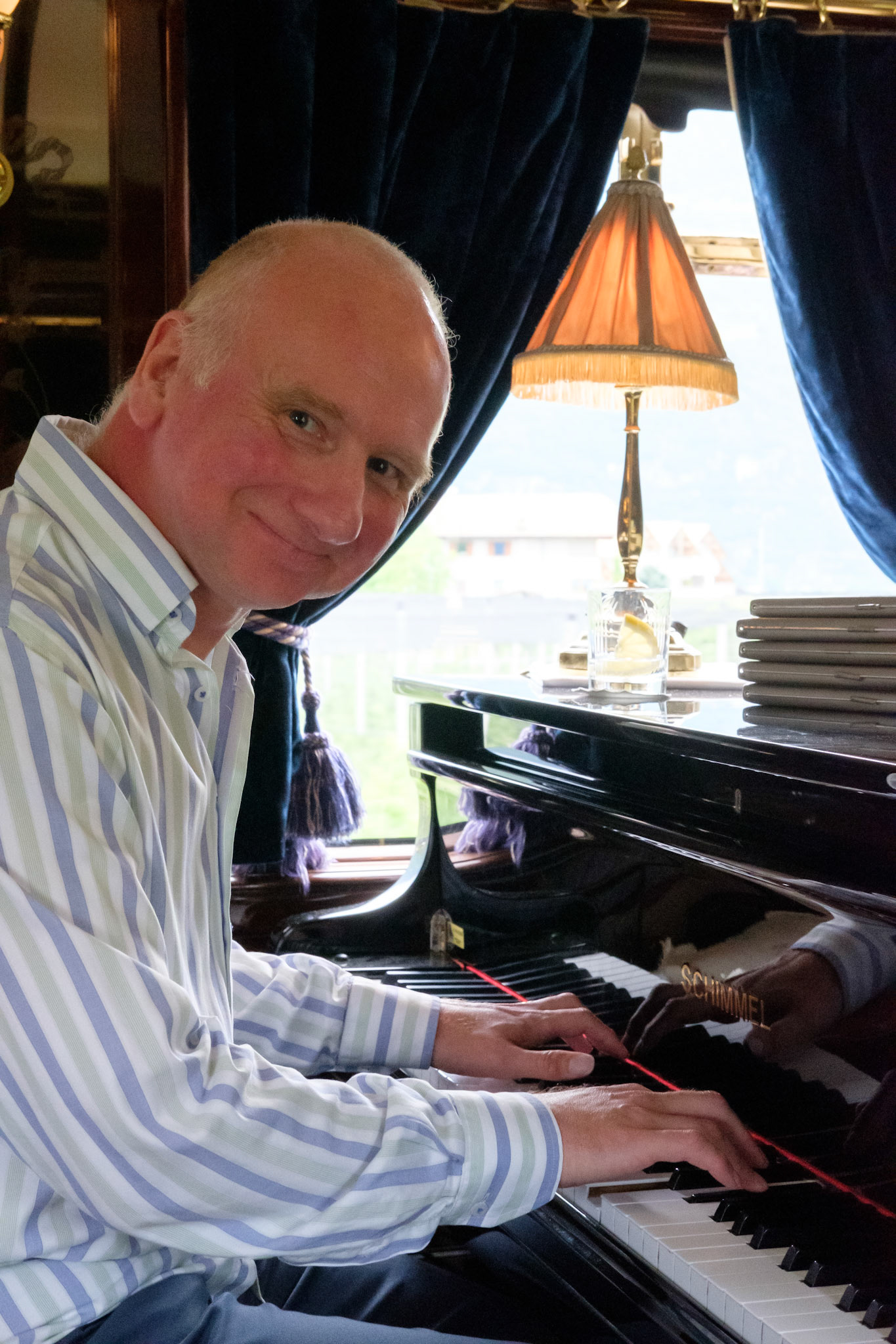 Alex playing the piano on the Orient Express