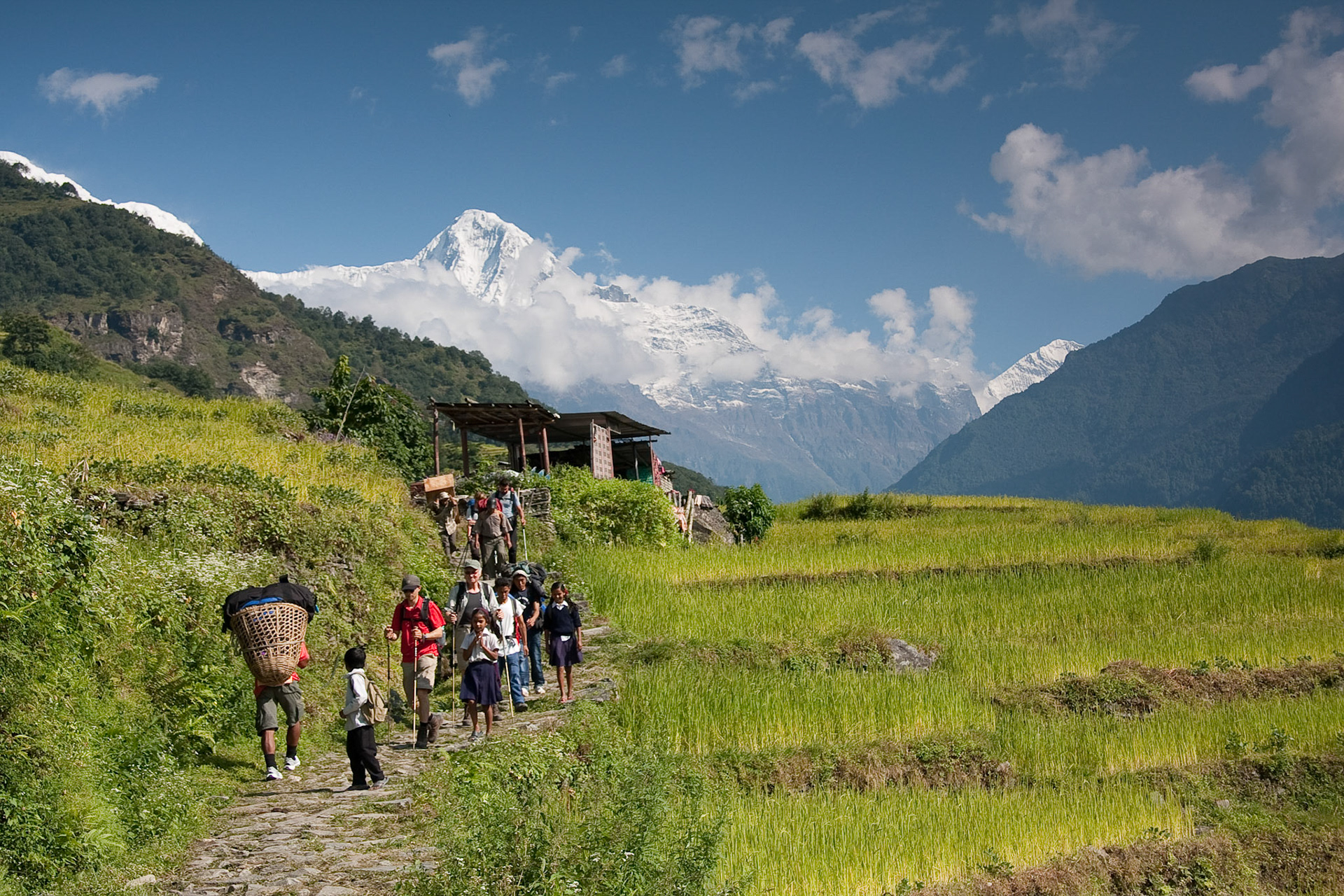 Trekkers, local children going to school and porters! Annapurna foothills