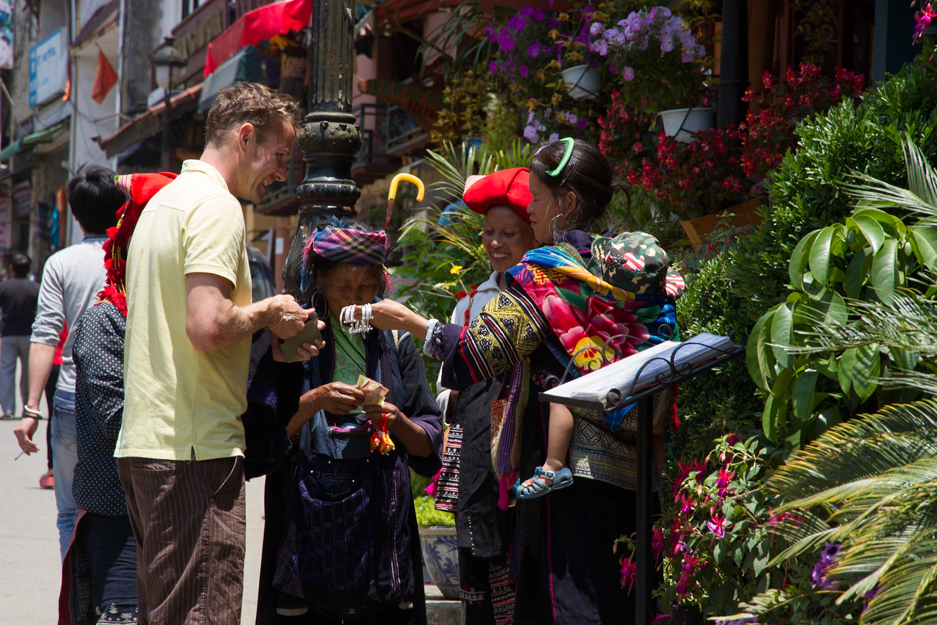 Black H'mong and Red Dao ladies selling to a tourist!