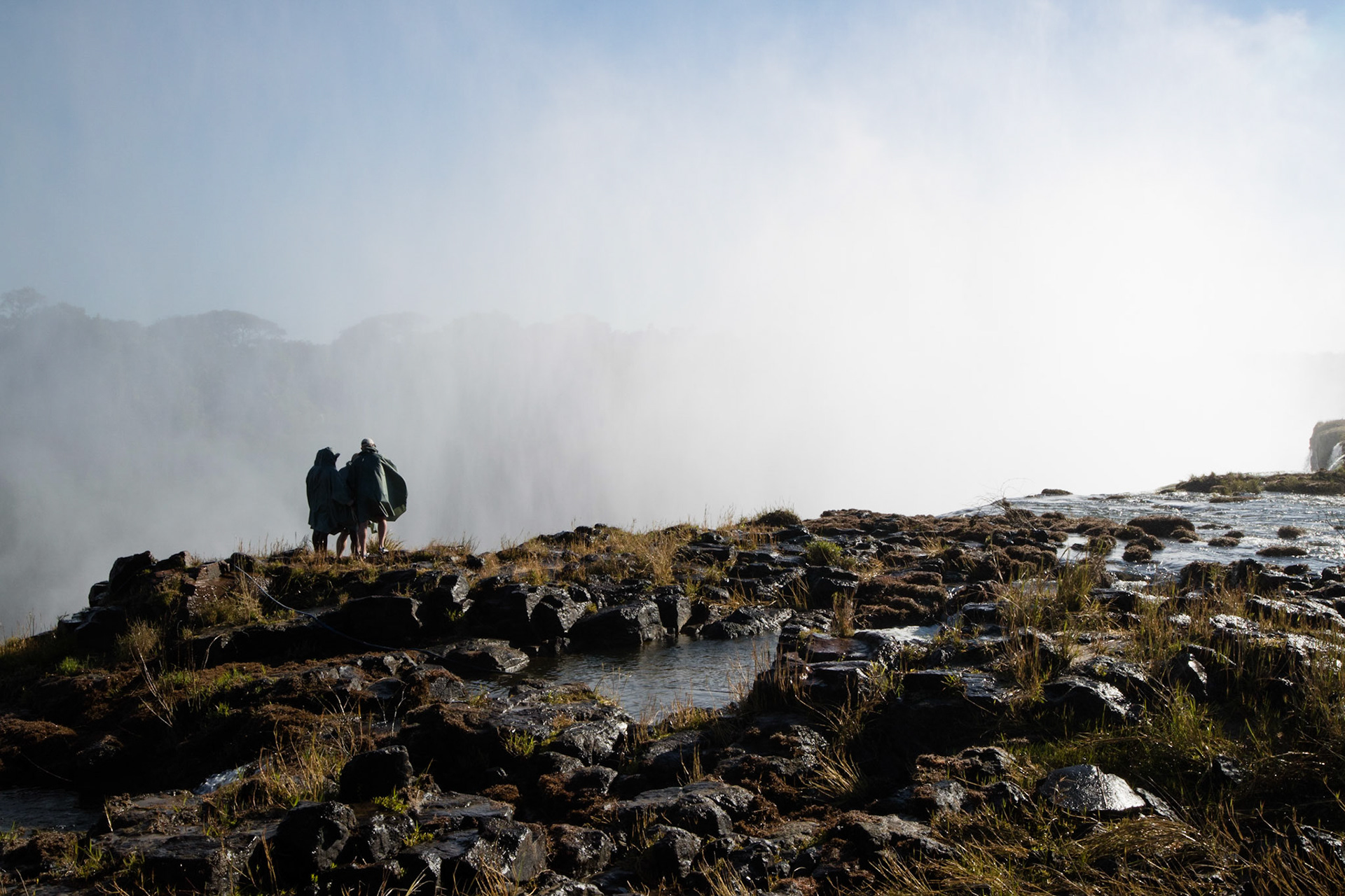 Alex standing on the edge of the Victoria Falls