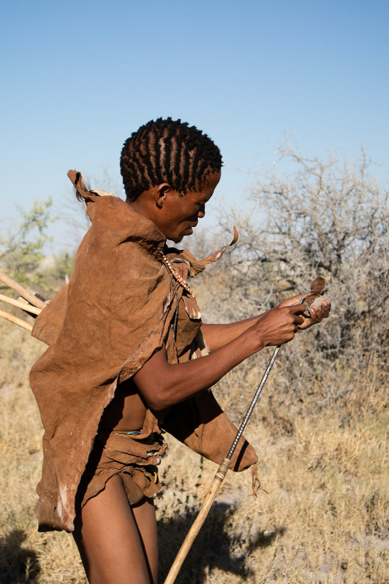 Bushman carving a palm nut to make jewellery