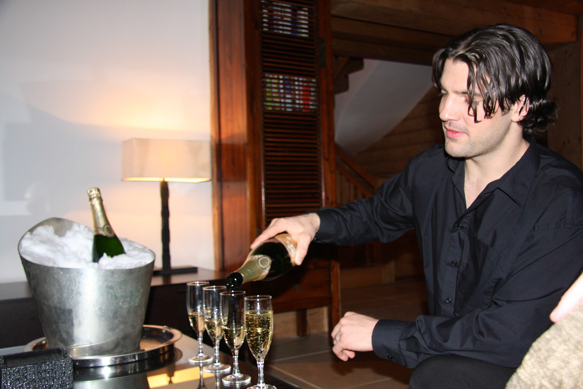Petr pouring the champagne