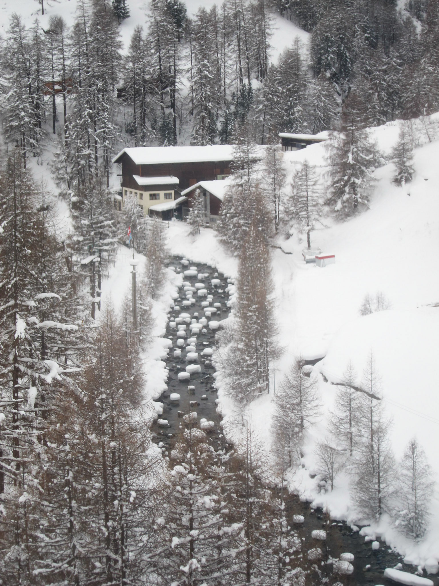 Snow on boulders in the river